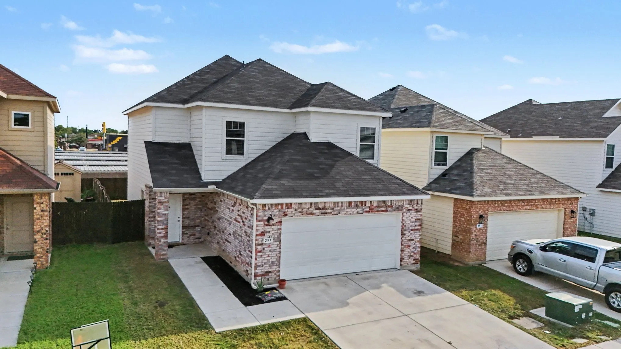 An elevated front view shows the home and its immediate surroundings.