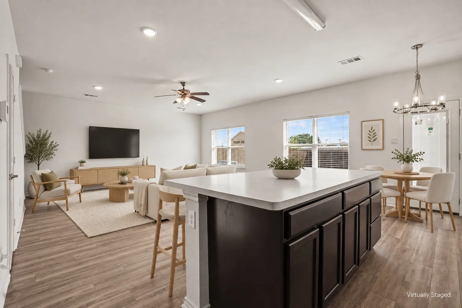 Virtually staged to illustrate furniture placement. The open living and dining areas connect directly to the kitchen for easy everyday living.