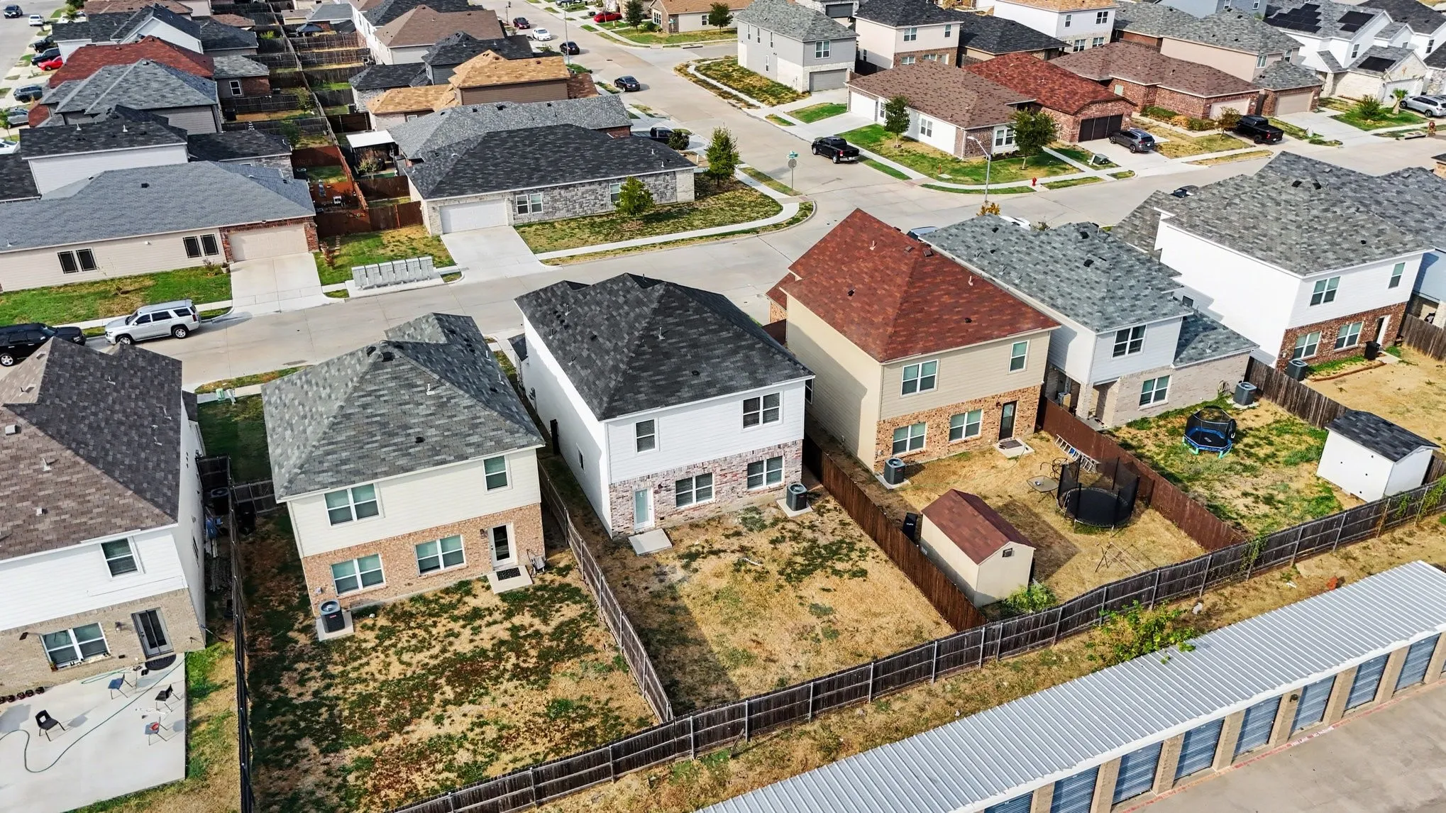 A neighborhood aerial viewed from behind the home.
