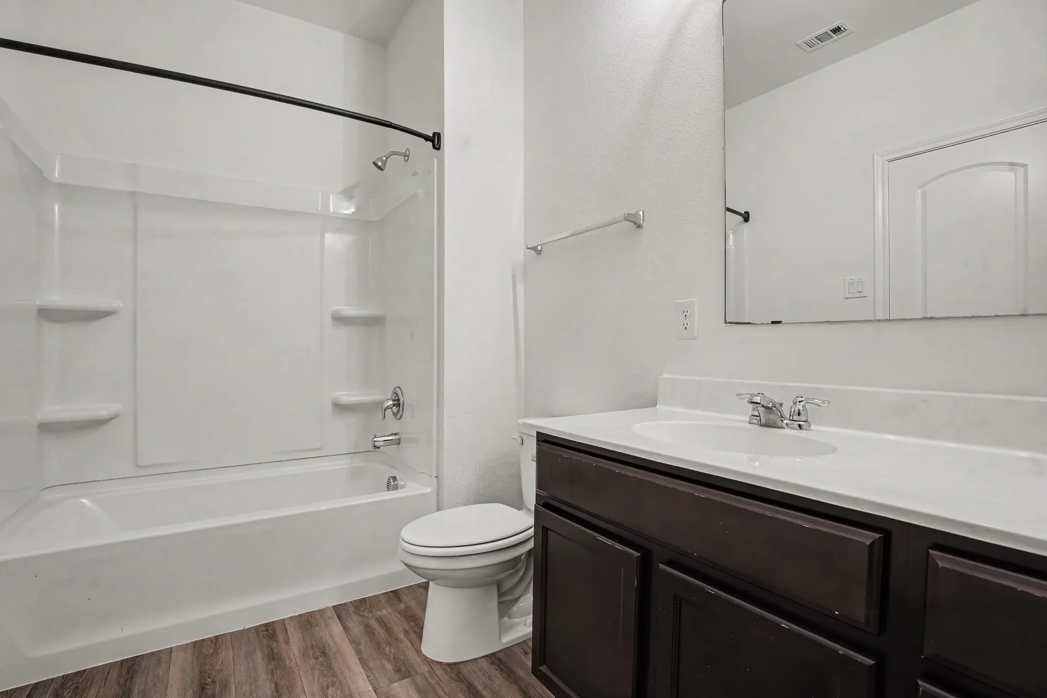 Primary bedroom with adjoining bathroom entrance.