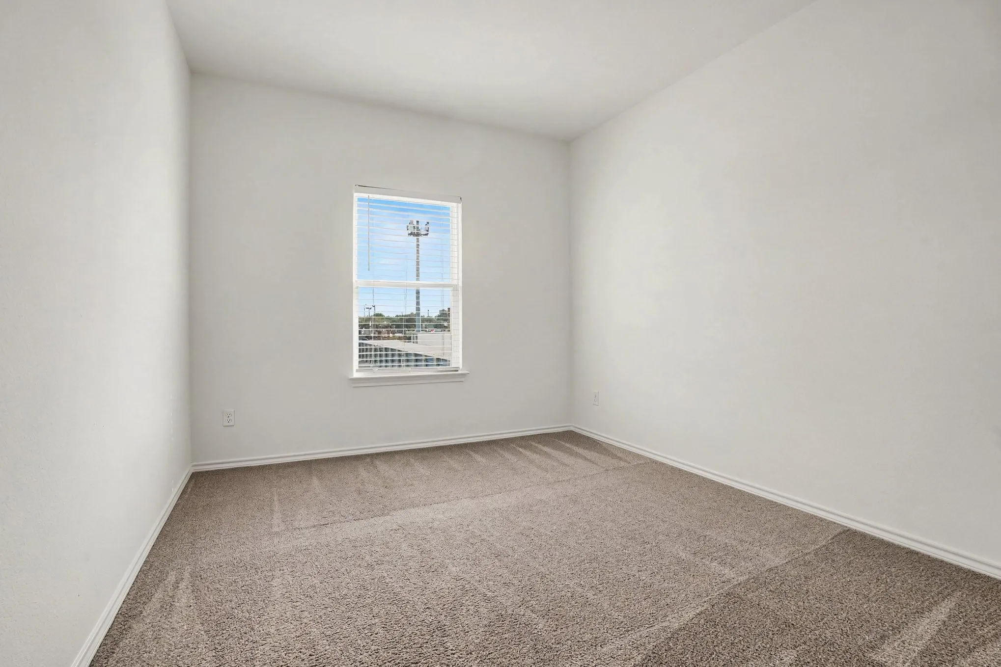 A secondary bedroom offers flexible space for sleeping, guests or a home office.
