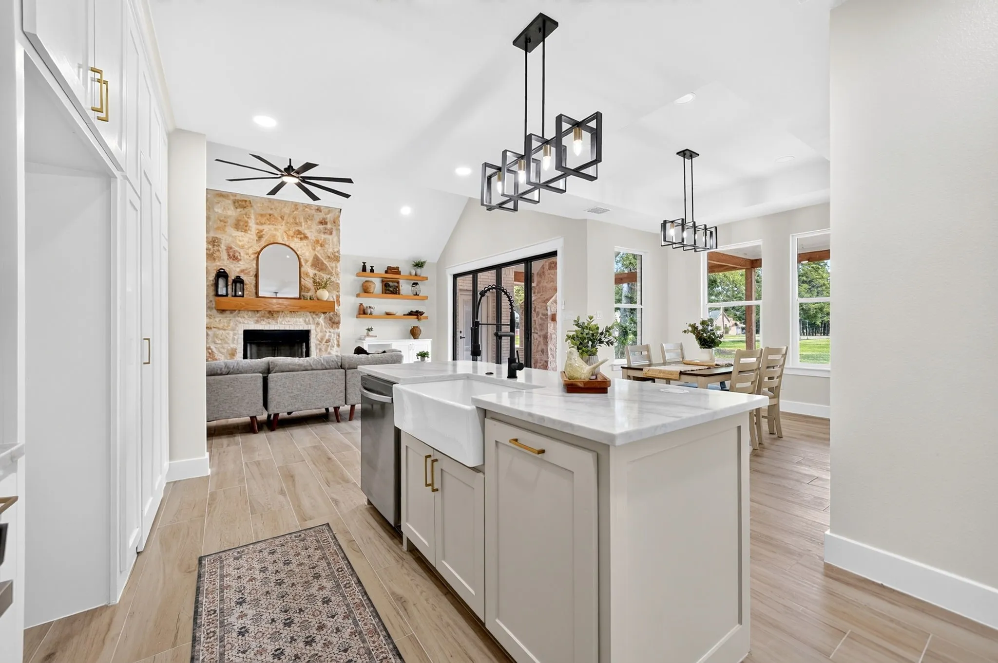 Central island kitchen with a farmhouse sink and light-toned cabinetry