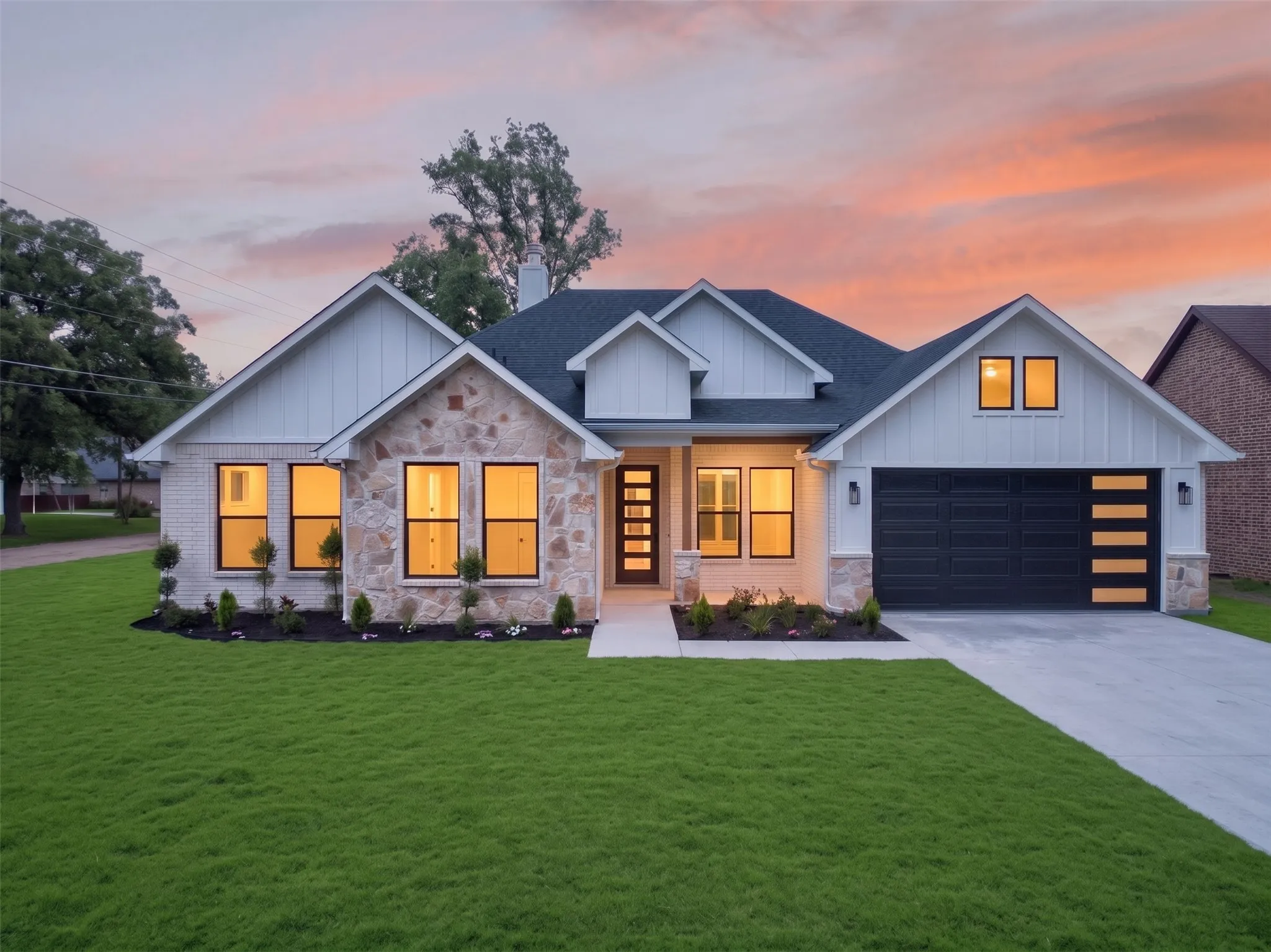 Contemporary residence with board and batten siding and stone accents