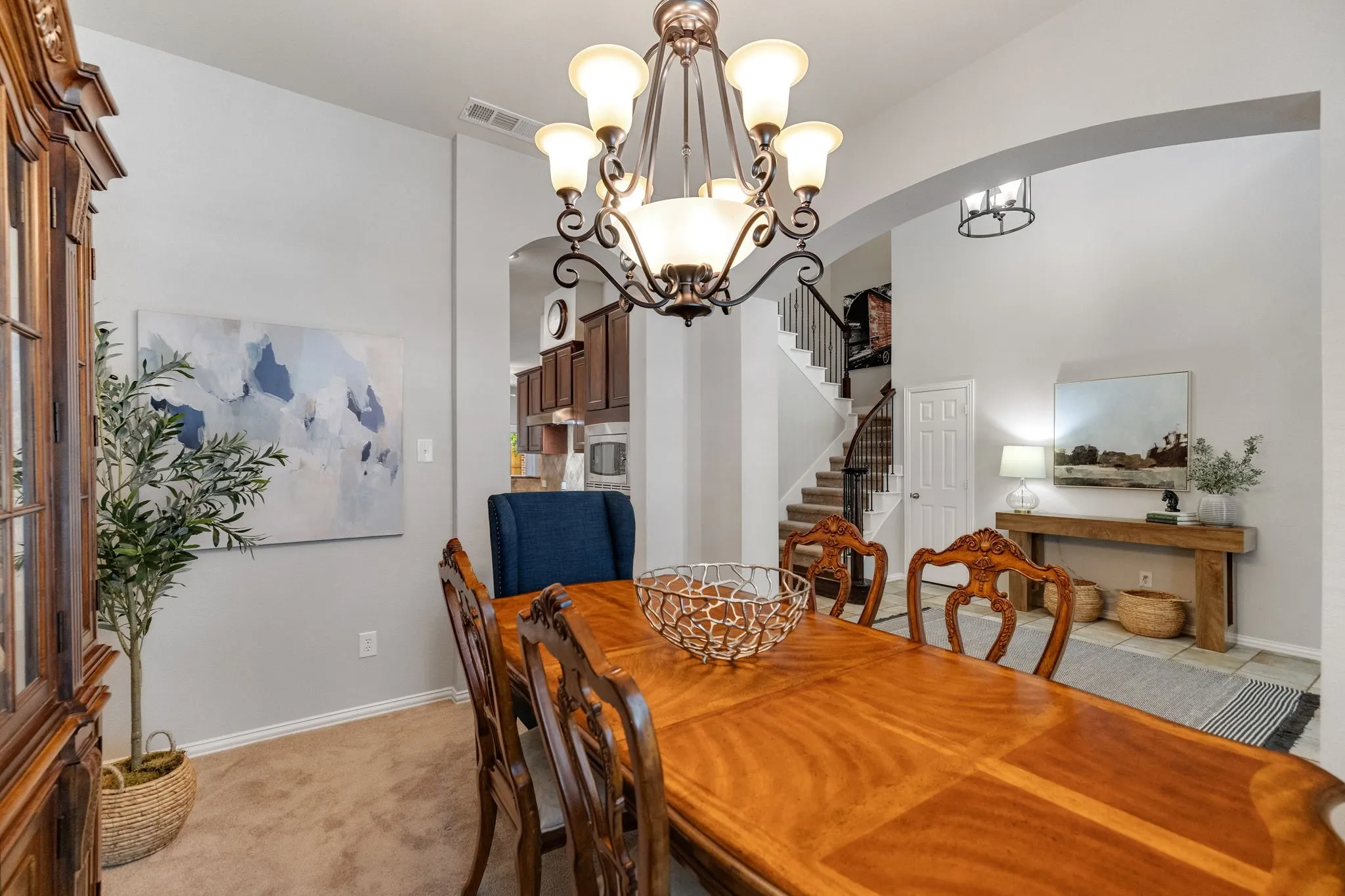 View from the corner of the dining room showing the arched entry and a peek into the kitchen and foyer.