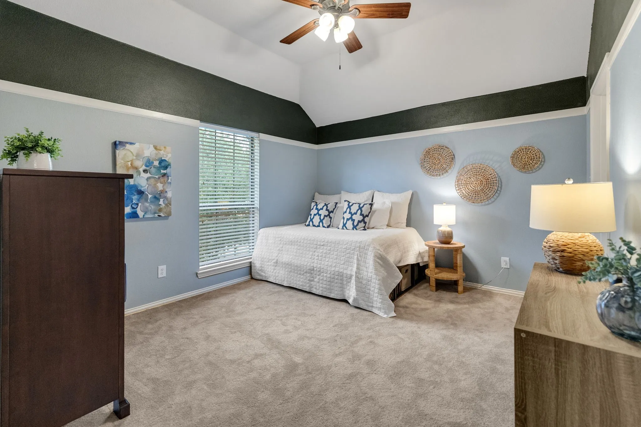 This is the second of three upstairs bedrooms.  Vaulted ceilings with upgraded molding & paint add interest to the room.  This room also has a spacious closet and has ensuite access to the jack and jill bathroom and plus it's own vanity & sink area.