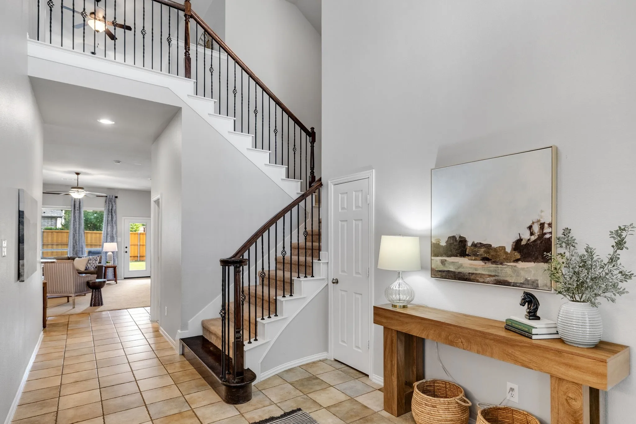 The open staircase with wrought iron balusters makes a lovely architectural statement.