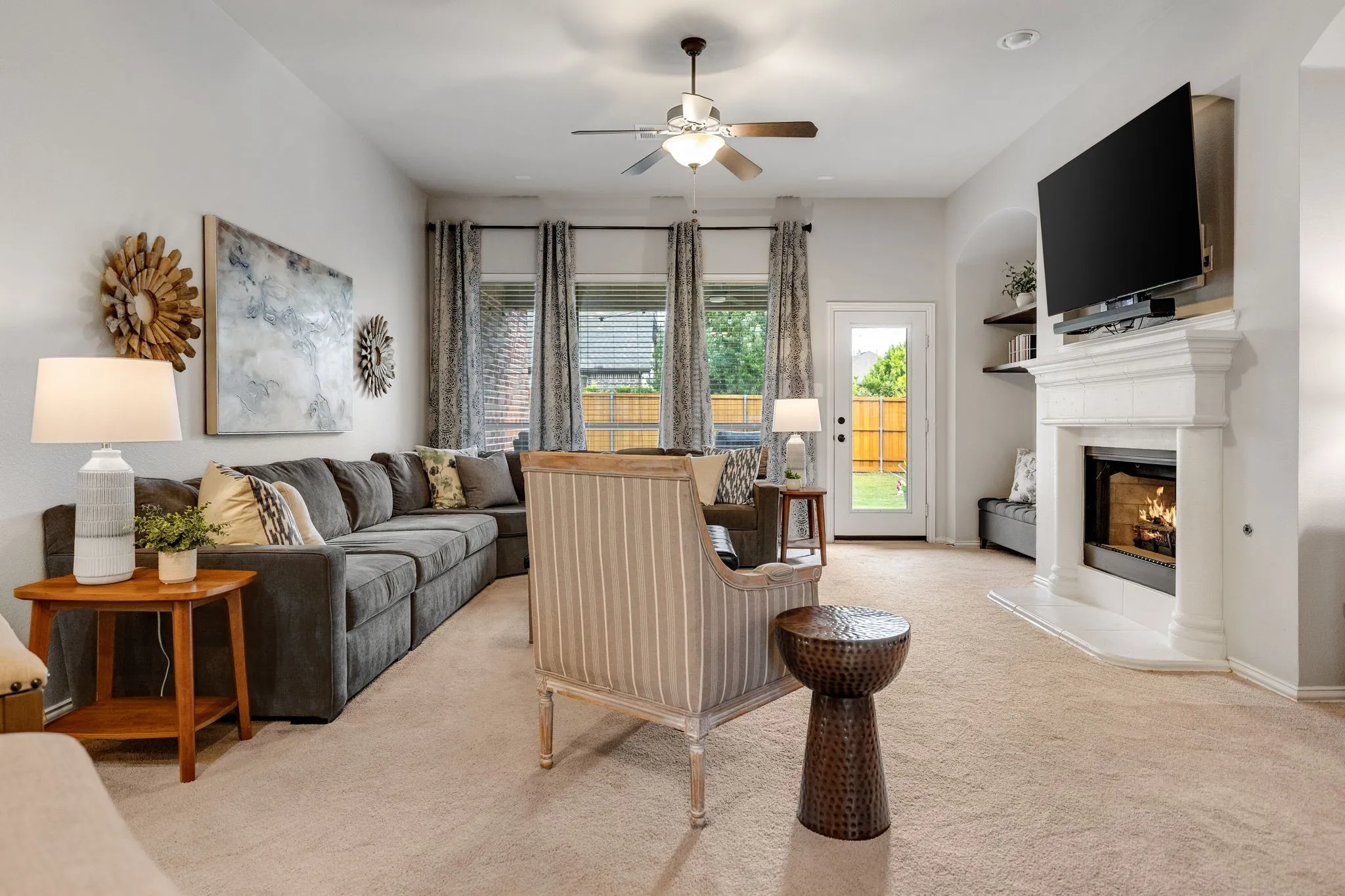 Enjoy the large family room with plenty of room for an oversized sectional in addition to other furniture & seating! Notice the tall ceilings, wall of windows with views of the backyard and the cast stone fireplace!