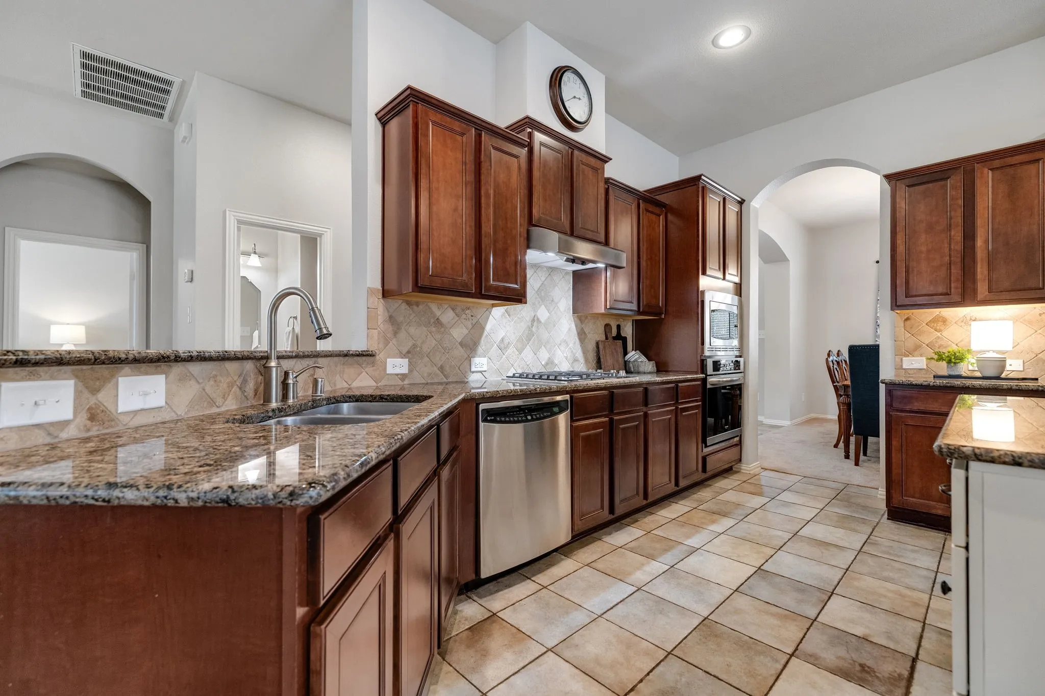 Stainless steel appliances including a newer gas cooktop.
