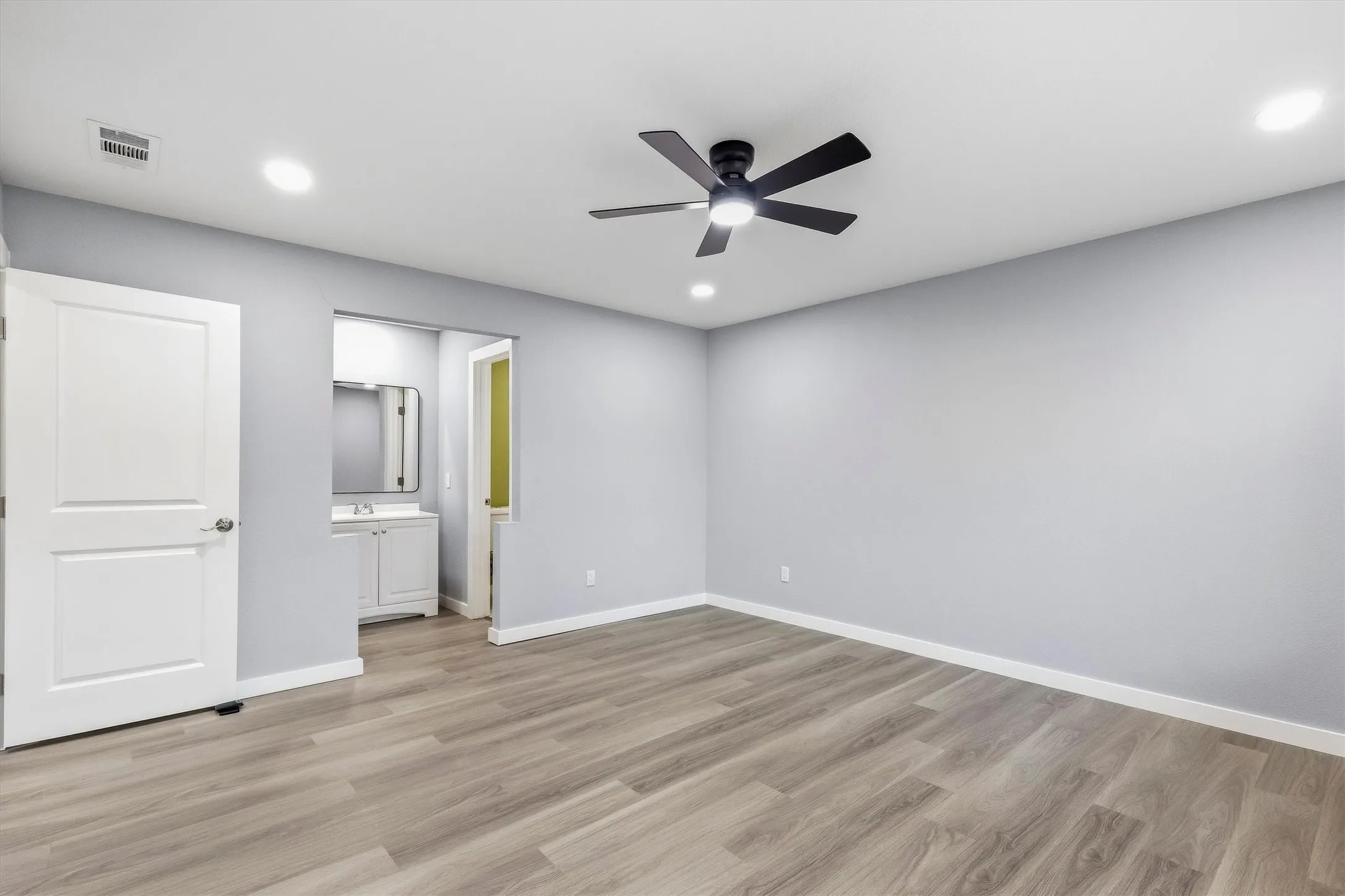Wood-finish flooring, recessed lighting, and a ceiling fan