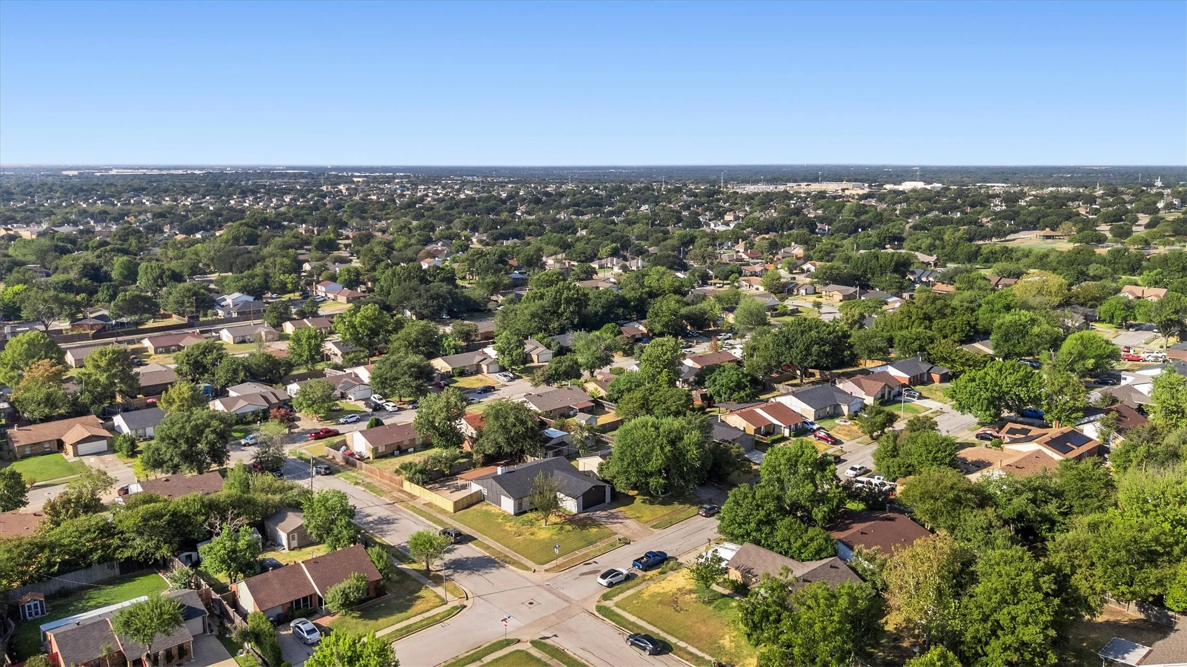 Residential neighborhood featuring single-story homes and mature tree canopy