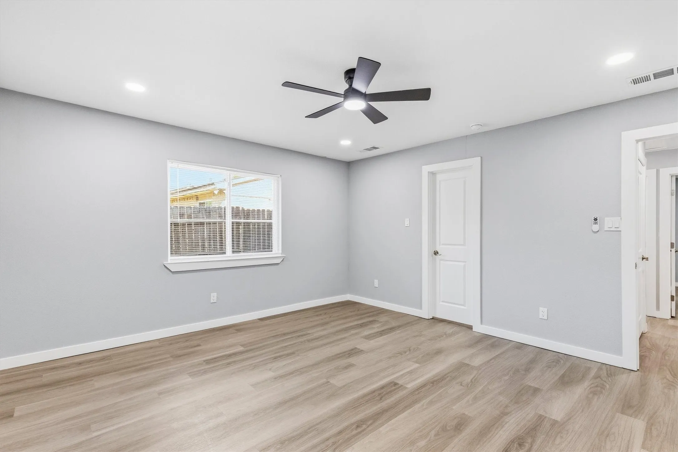 Wood-finish flooring, recessed lighting, and a modern ceiling fan