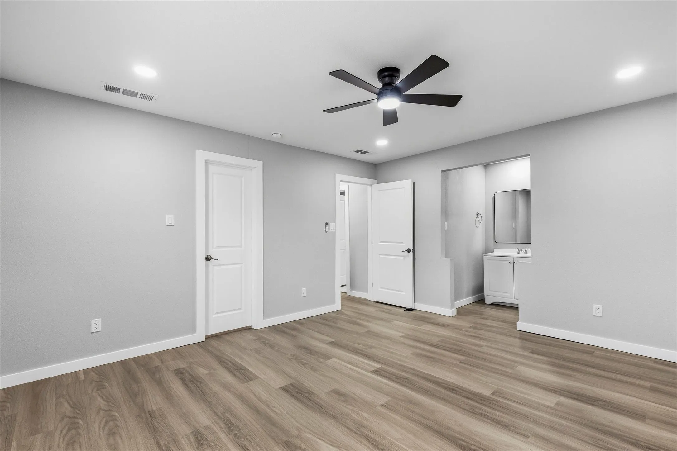 Wood-finish flooring, recessed lighting, and a modern ceiling fan