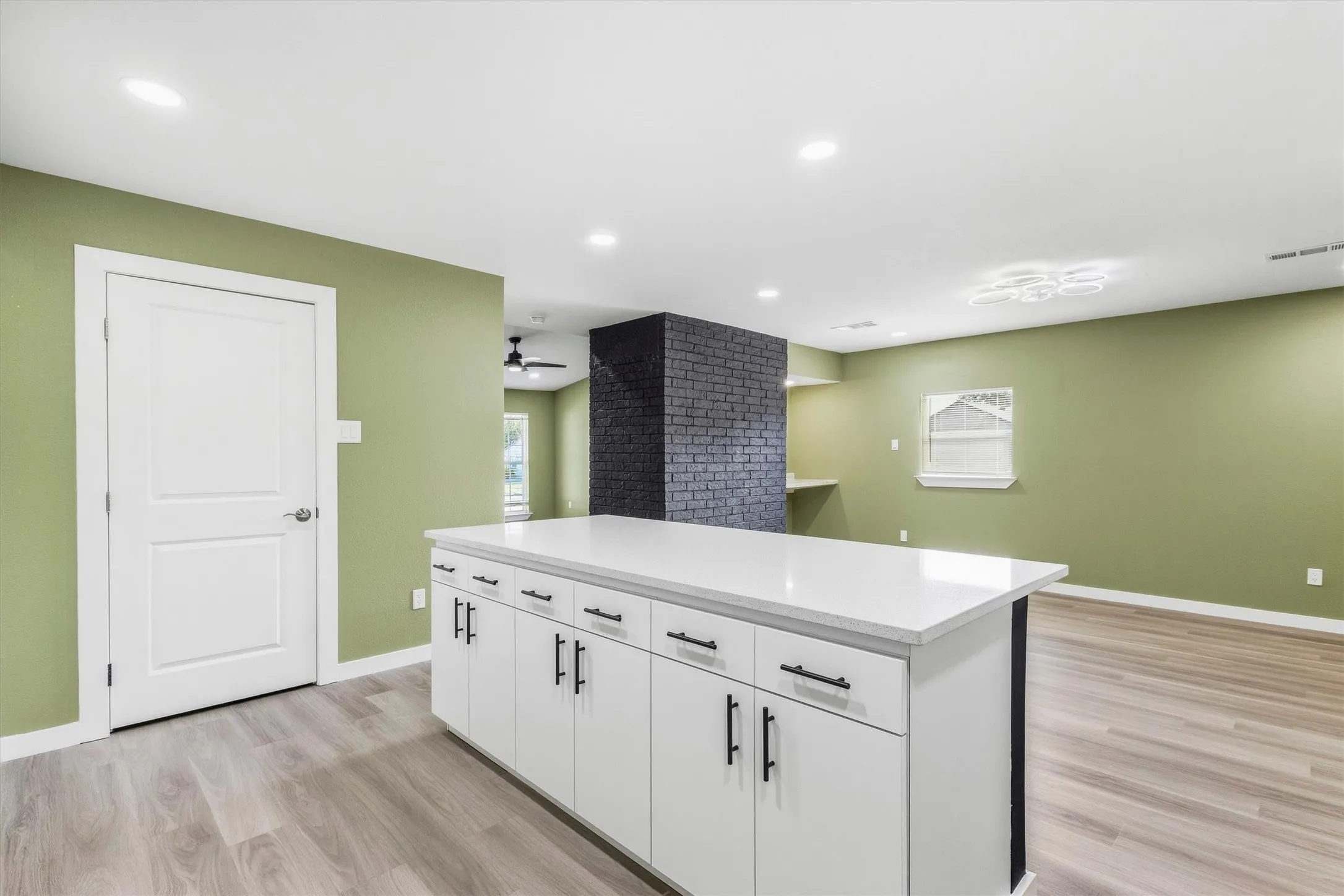 Central kitchen island with white cabinetry and a light-toned countertop