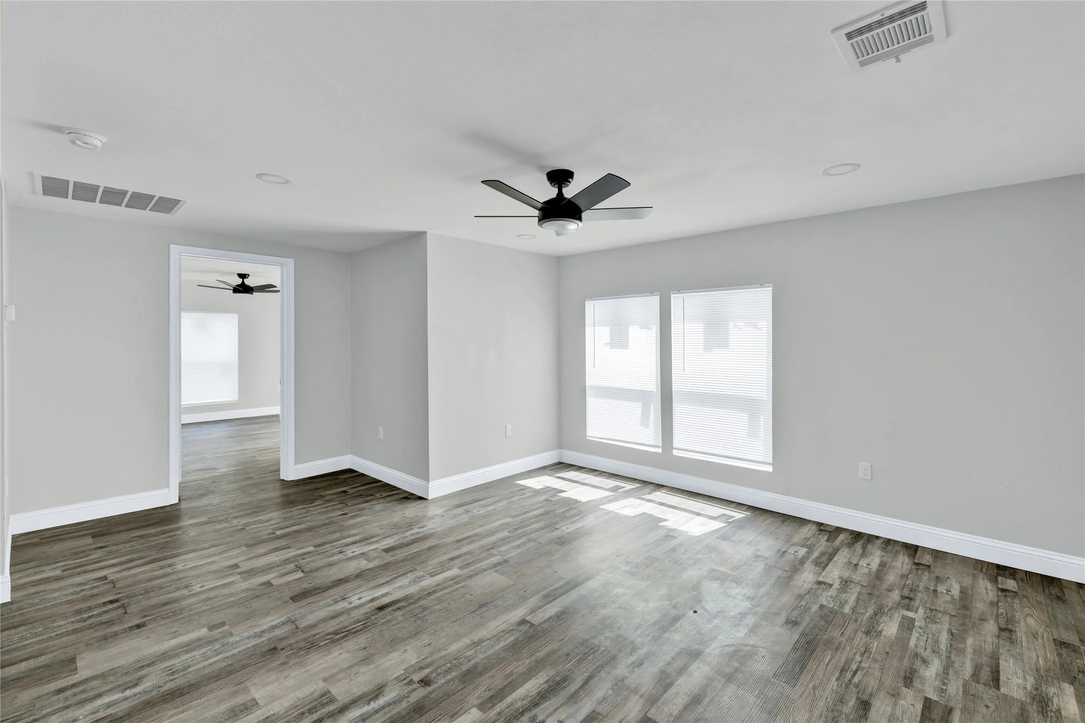 Wood-finish flooring, recessed lighting, and a ceiling fan with light kit