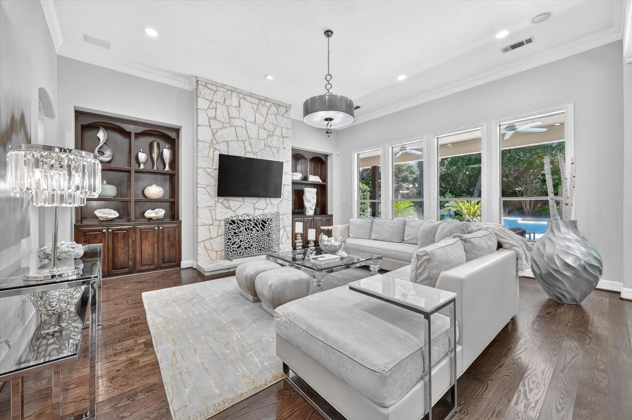 Stone-clad fireplace feature with built-in dark wood cabinetry