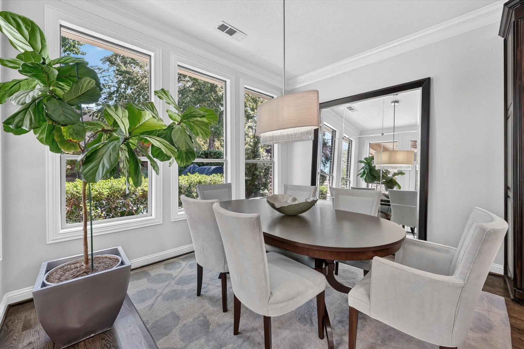 Crown molding, recessed lighting, and wood-finish flooring
