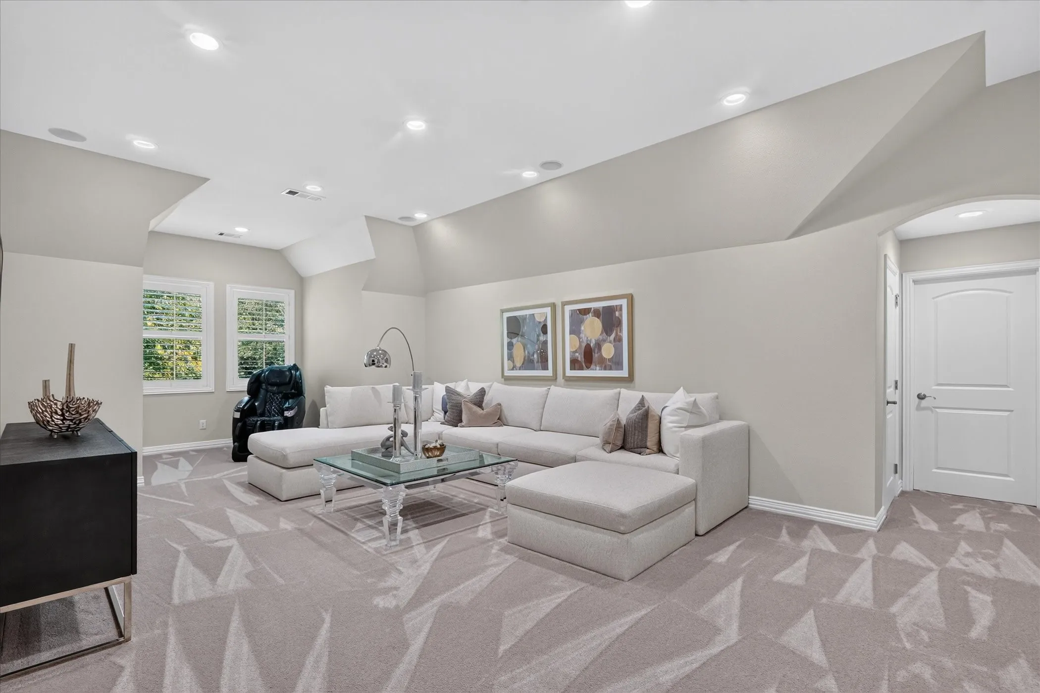 Recessed lighting, arched doorway, and patterned carpeting