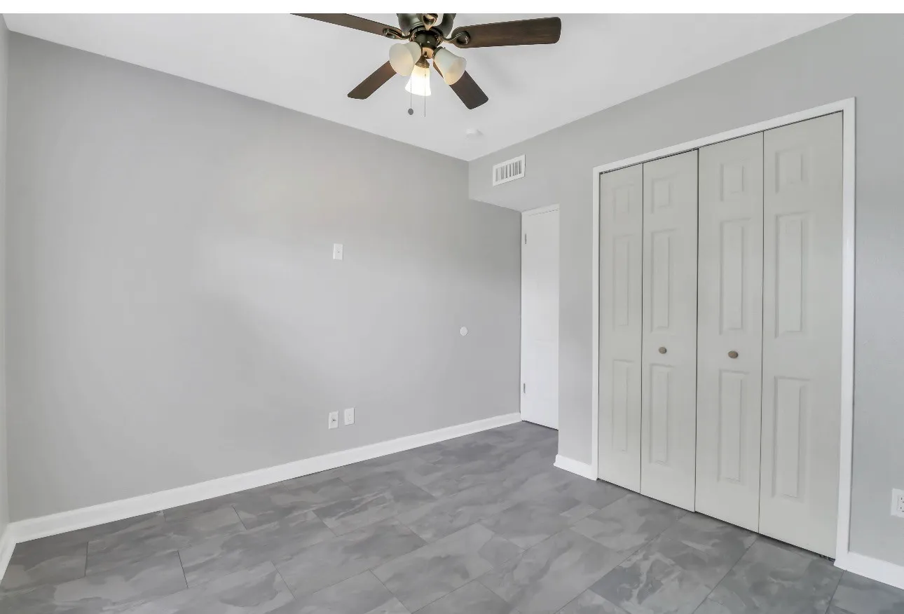 Room featuring grey walls, contemporary tile flooring, and a ceiling fan