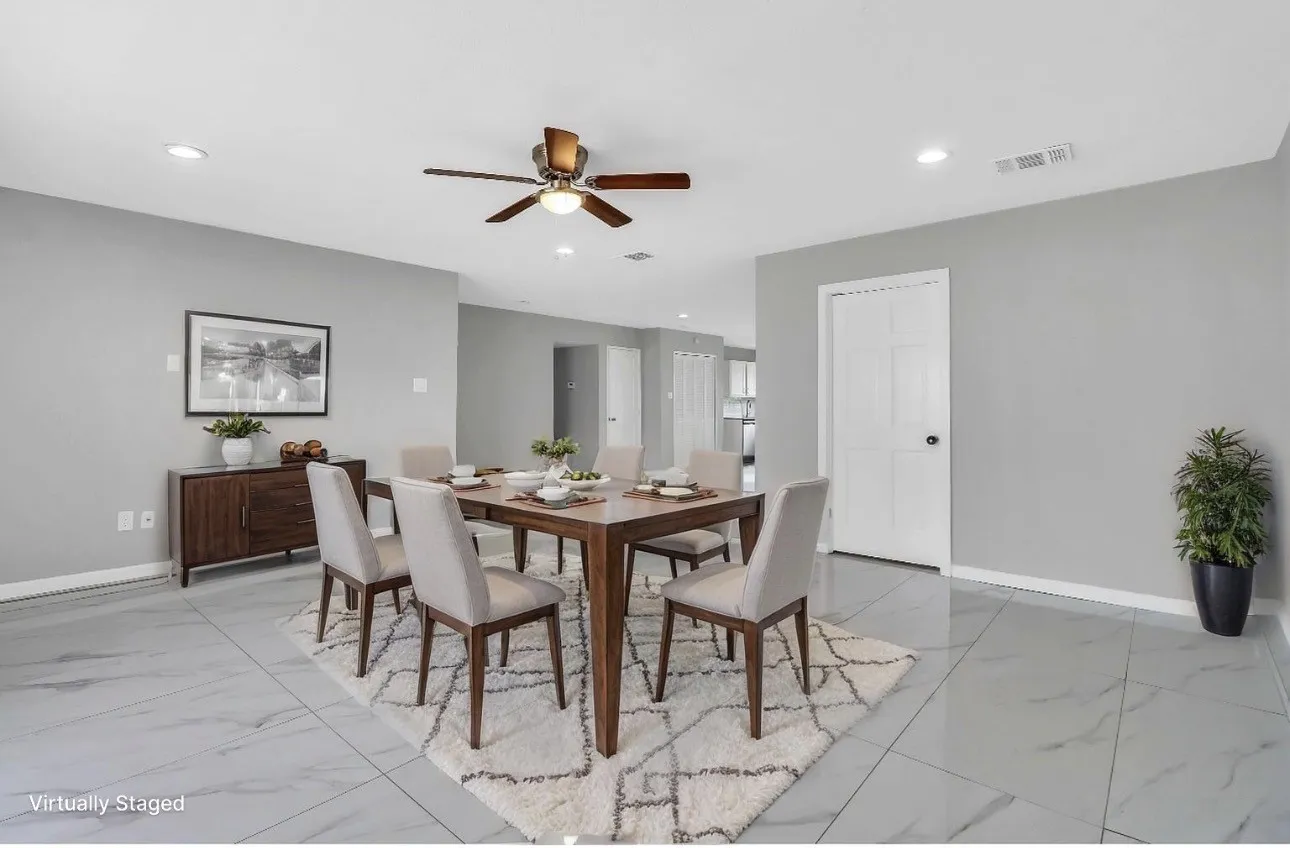 Spacious dining area featuring large format tile flooring, a contemporary ceiling fan, recessed lighting, and light grey wall tones