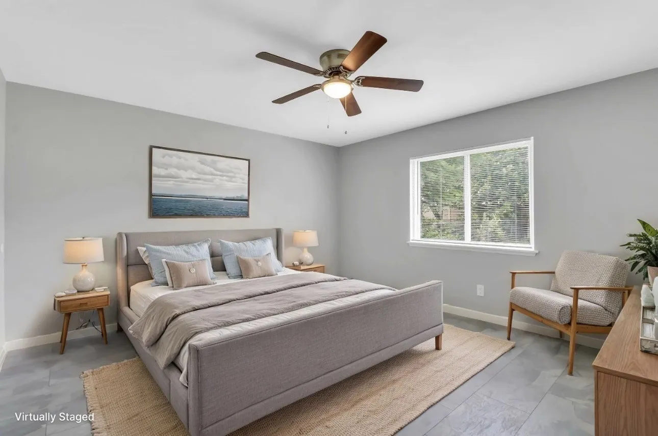 Room featuring light gray wall paint, gray tile flooring, a single window, and a ceiling fan with integrated lighting