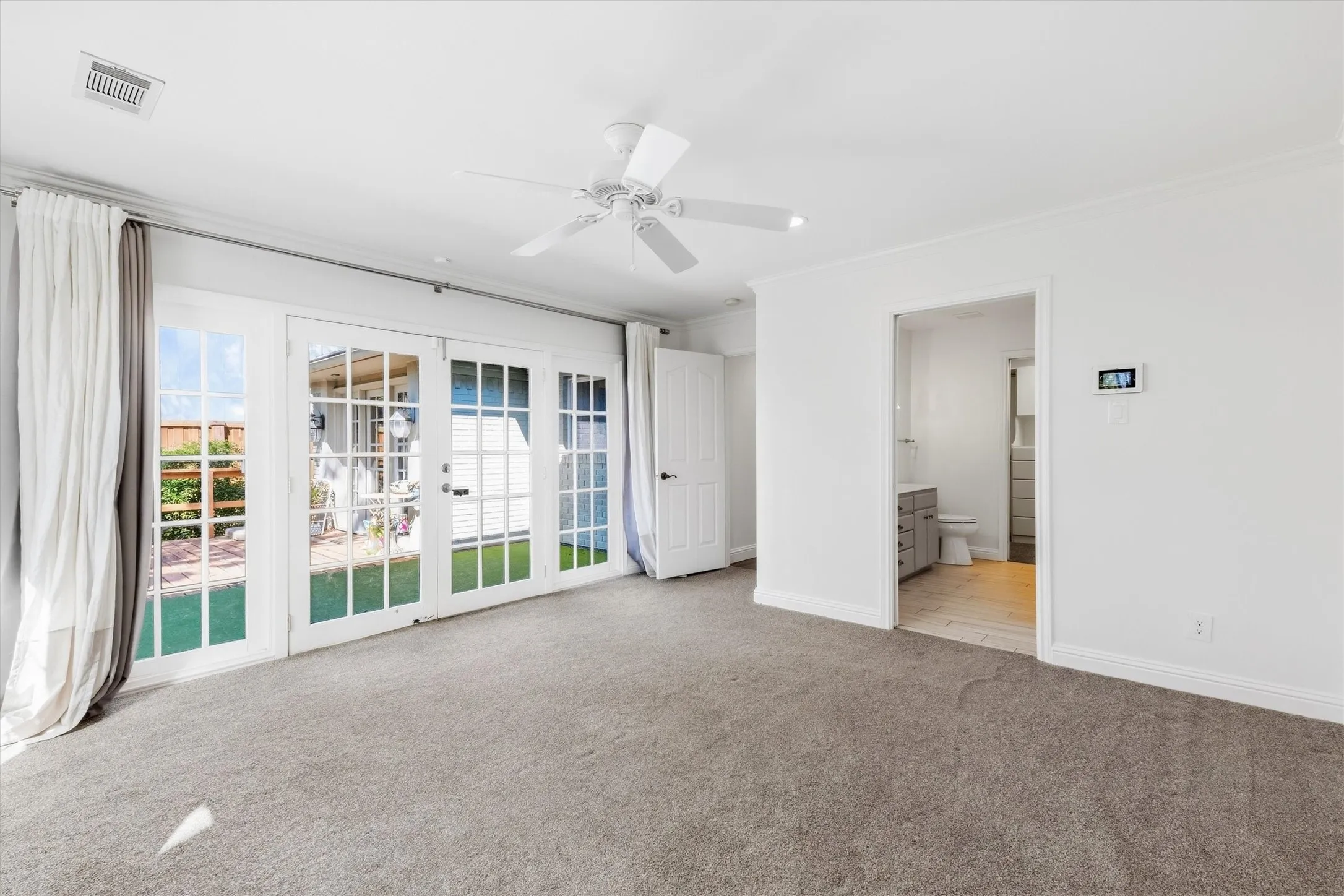 Plush carpeting and white walls with crown molding