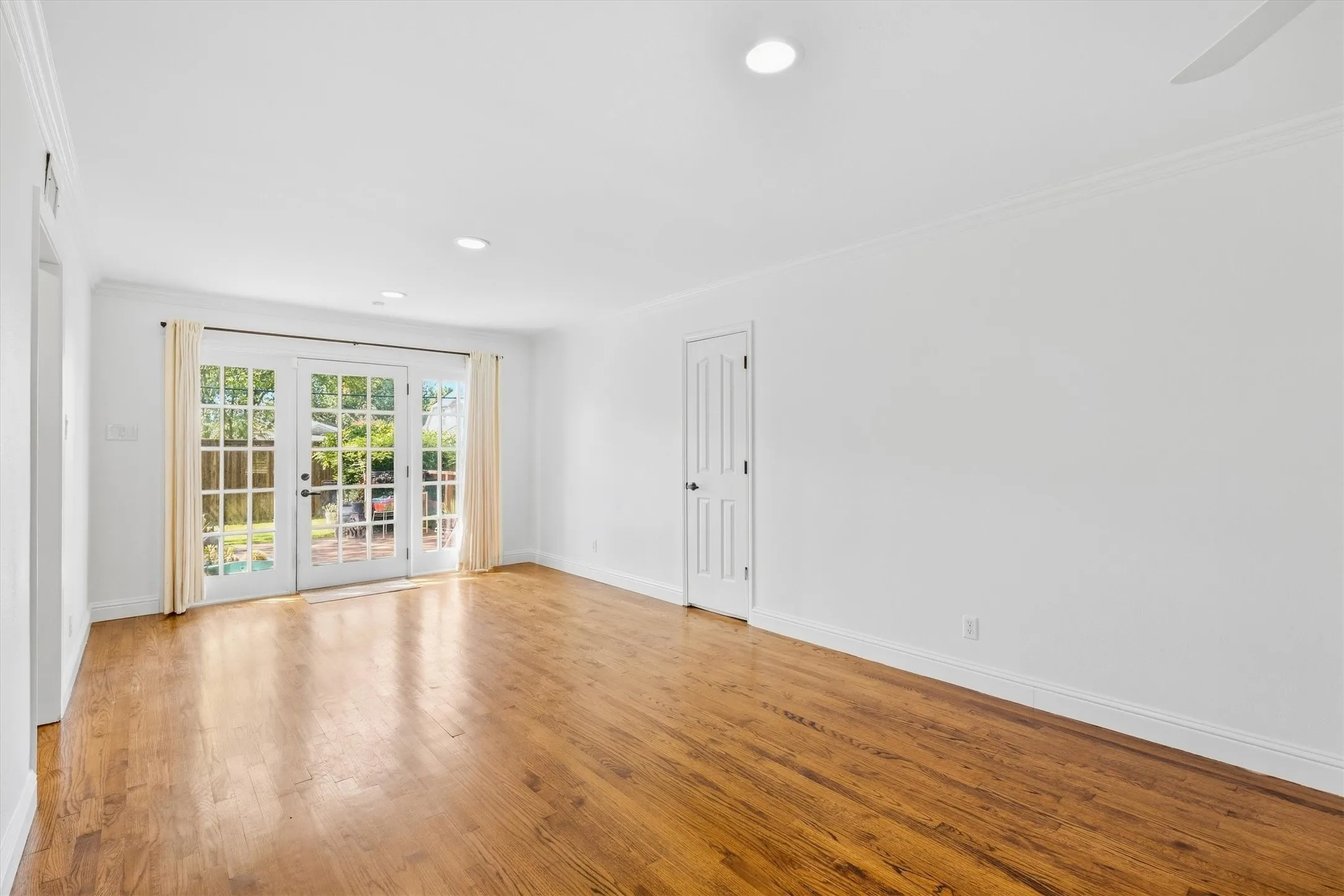 Hardwood flooring throughout, featuring recessed lighting and crown molding