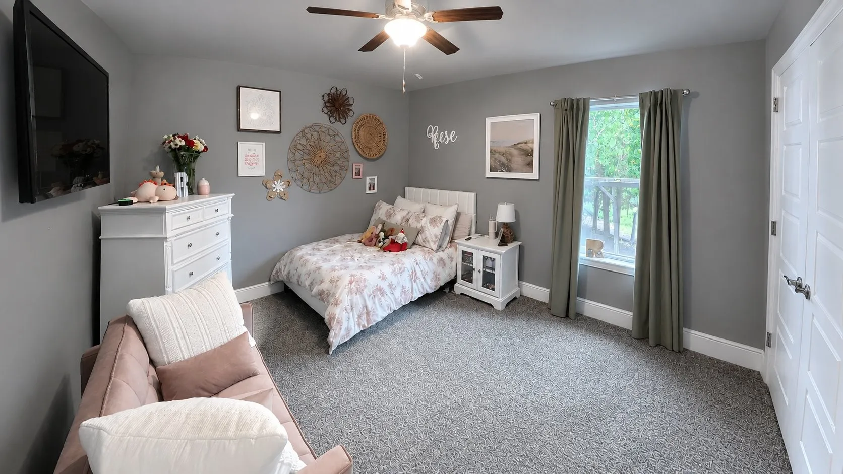 Carpeted bedroom featuring a ceiling fan, a window, and paneled doors