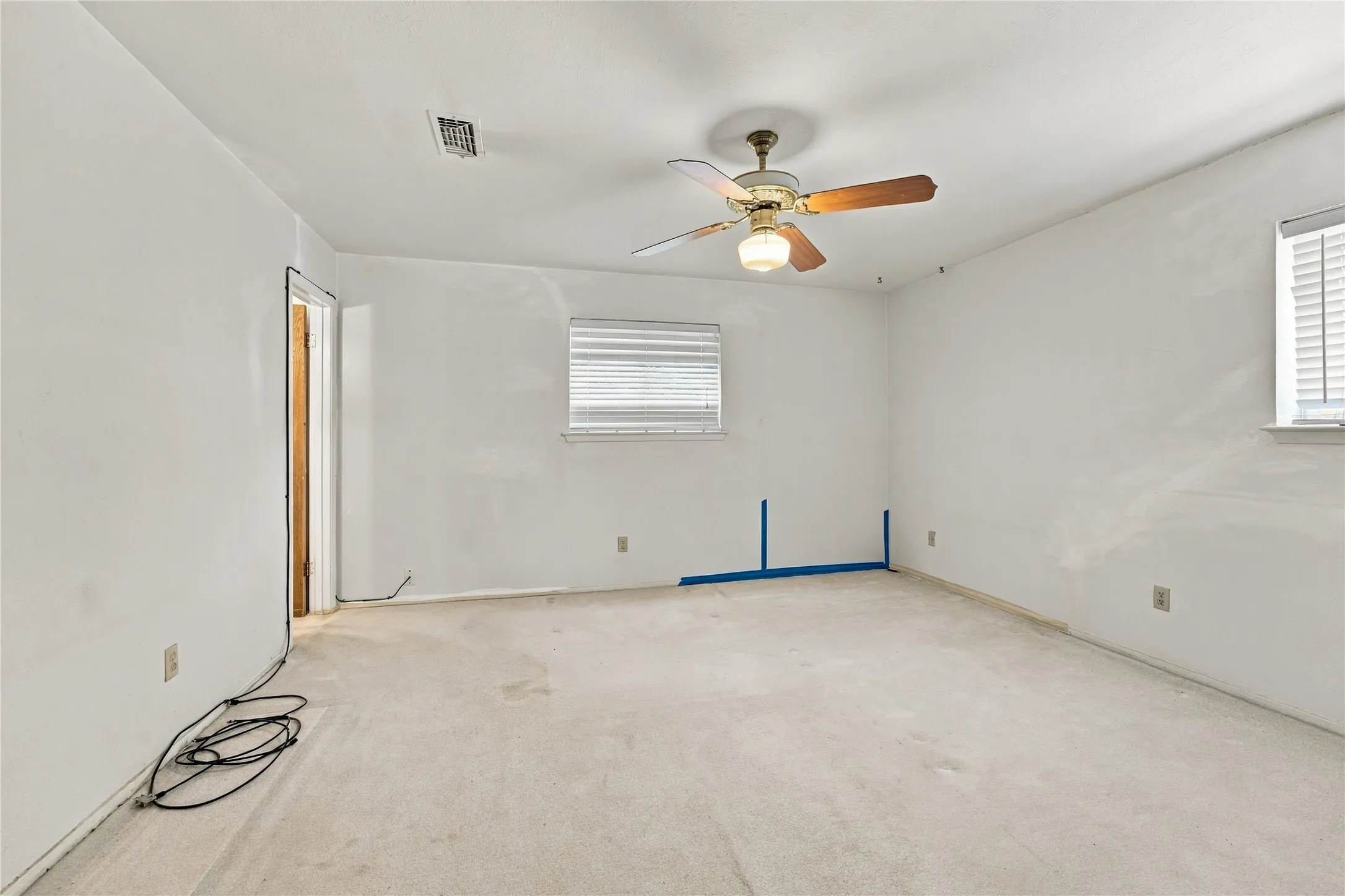 Carpeted flooring, ceiling fan with integrated lighting, multiple windows with blinds, white wall finishes