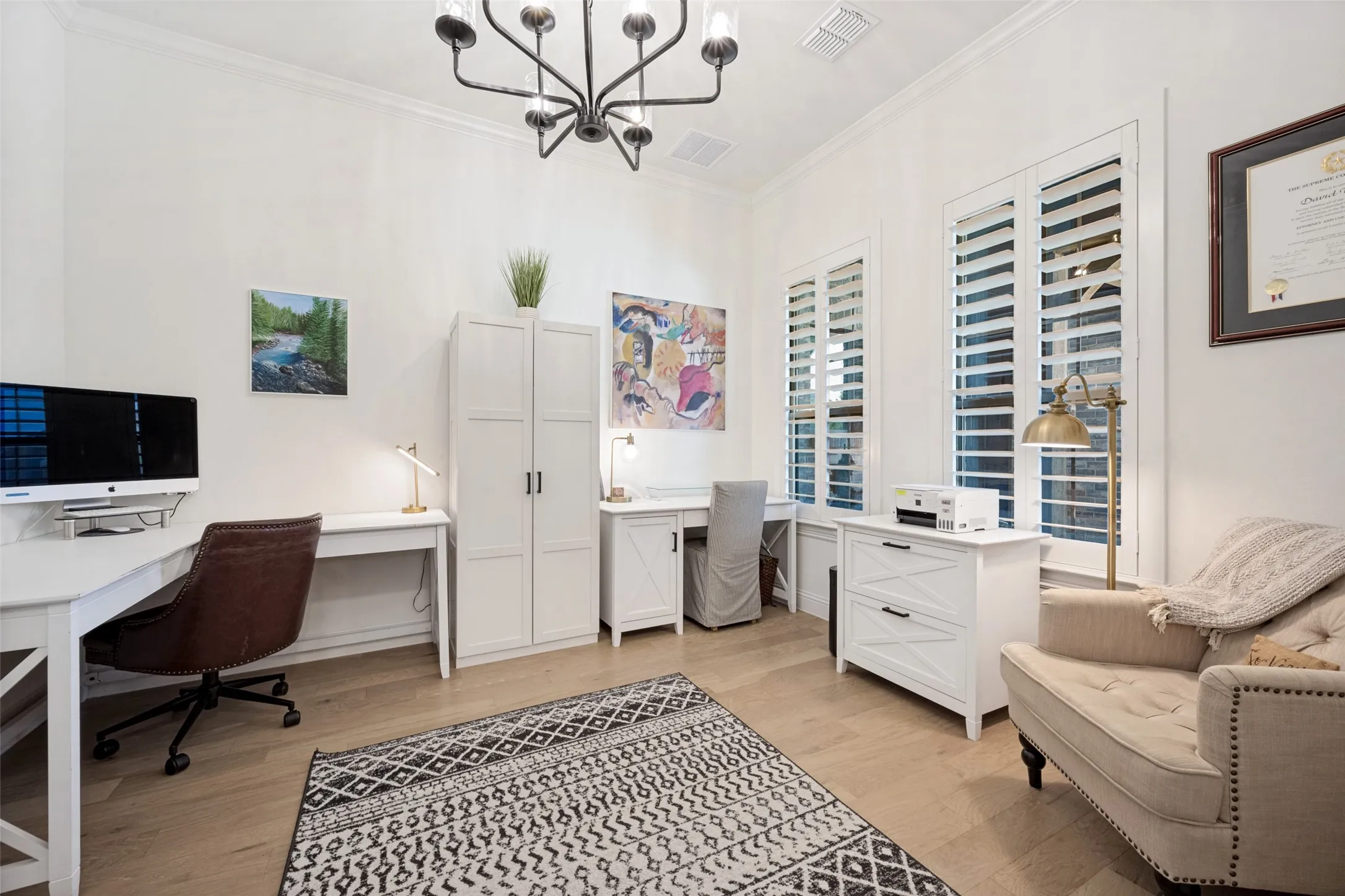 Crown molding, light wood-finish flooring, and white plantation shutters