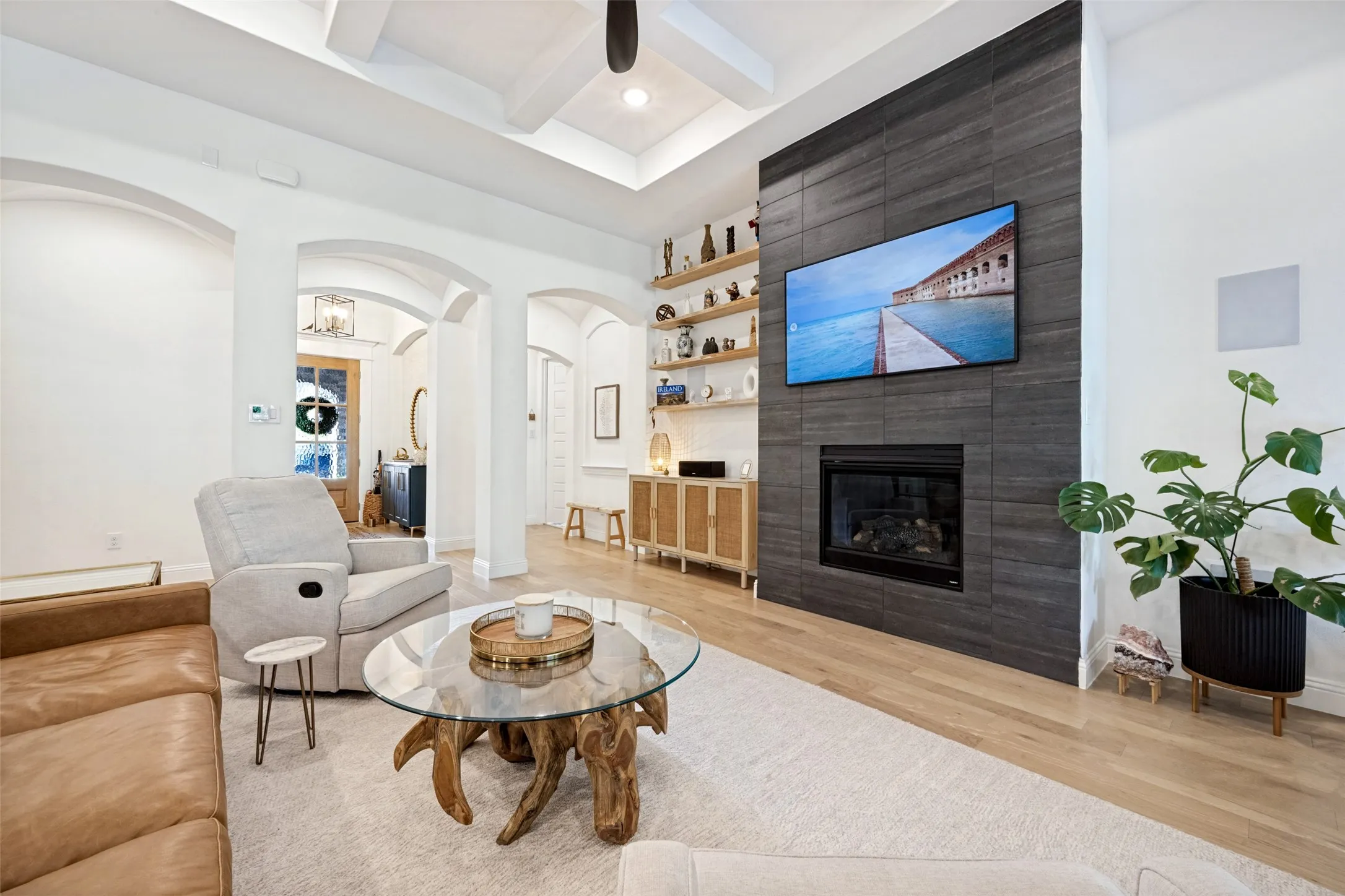 Tray ceiling with exposed beams, recessed lighting, and a ceiling fan