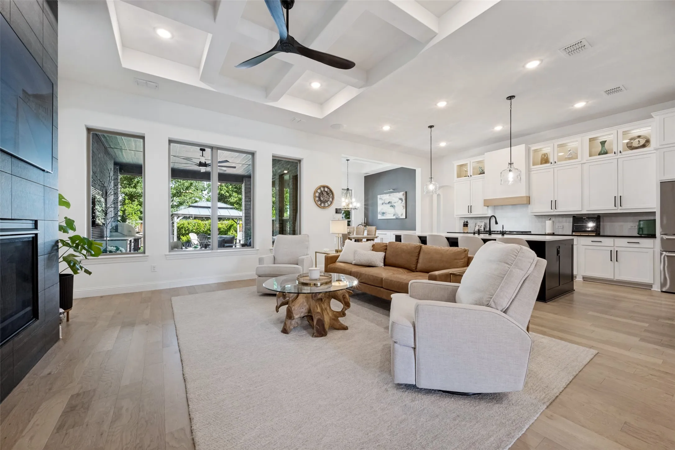 Coffered ceiling with recessed lighting and a ceiling fan