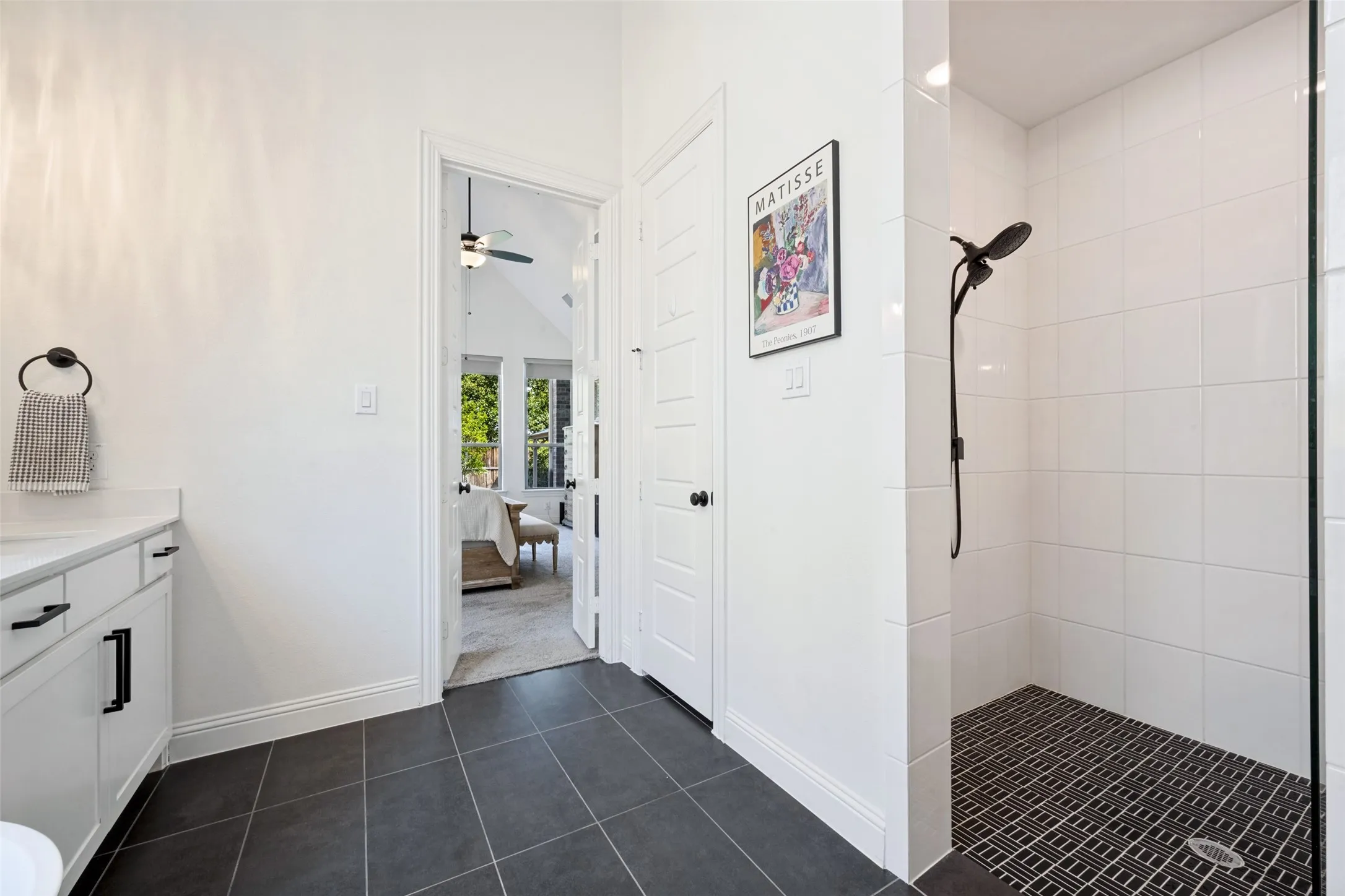 Walk-in shower with white subway tile walls and mosaic tile flooring