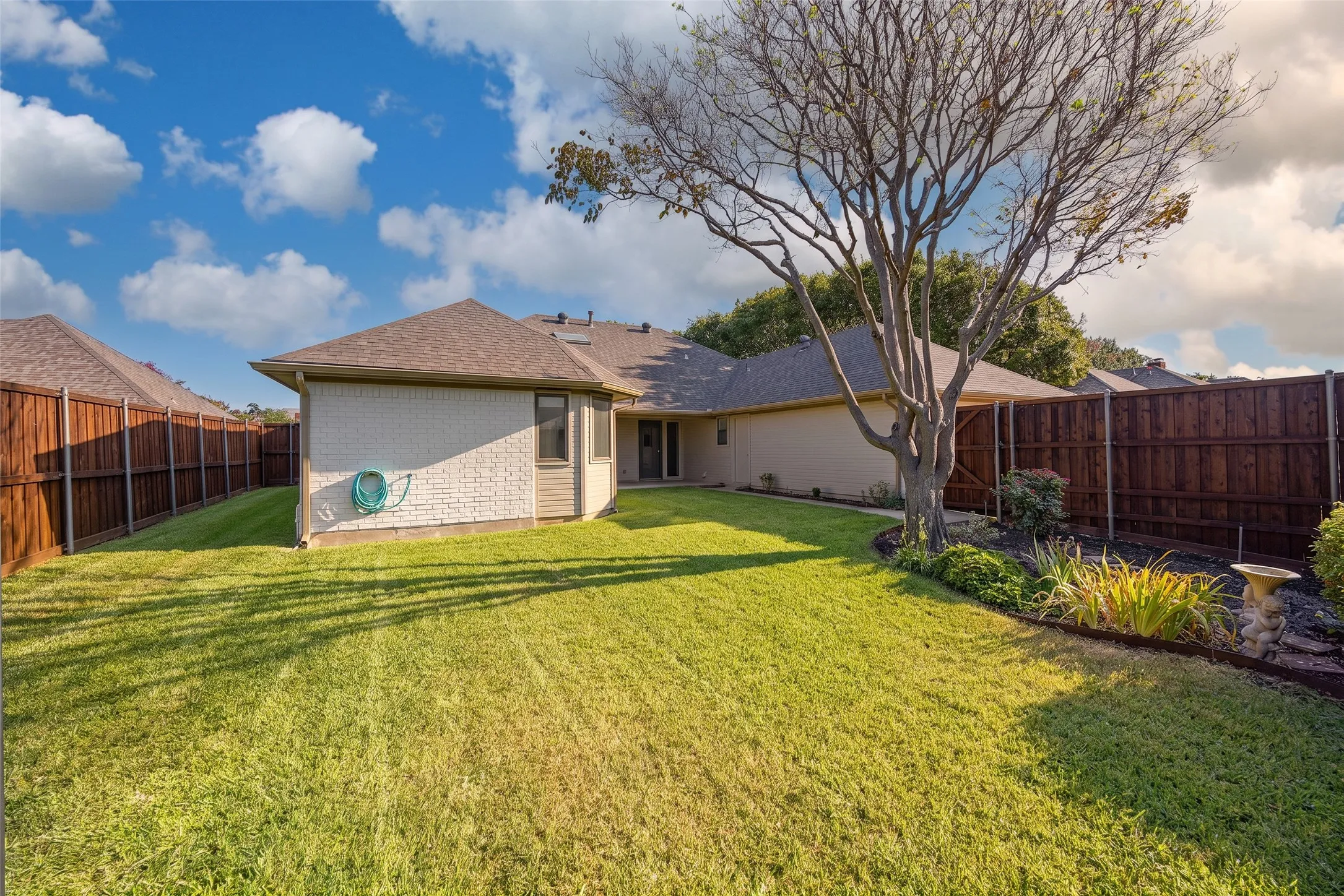 Rear exterior view of the home with patio area