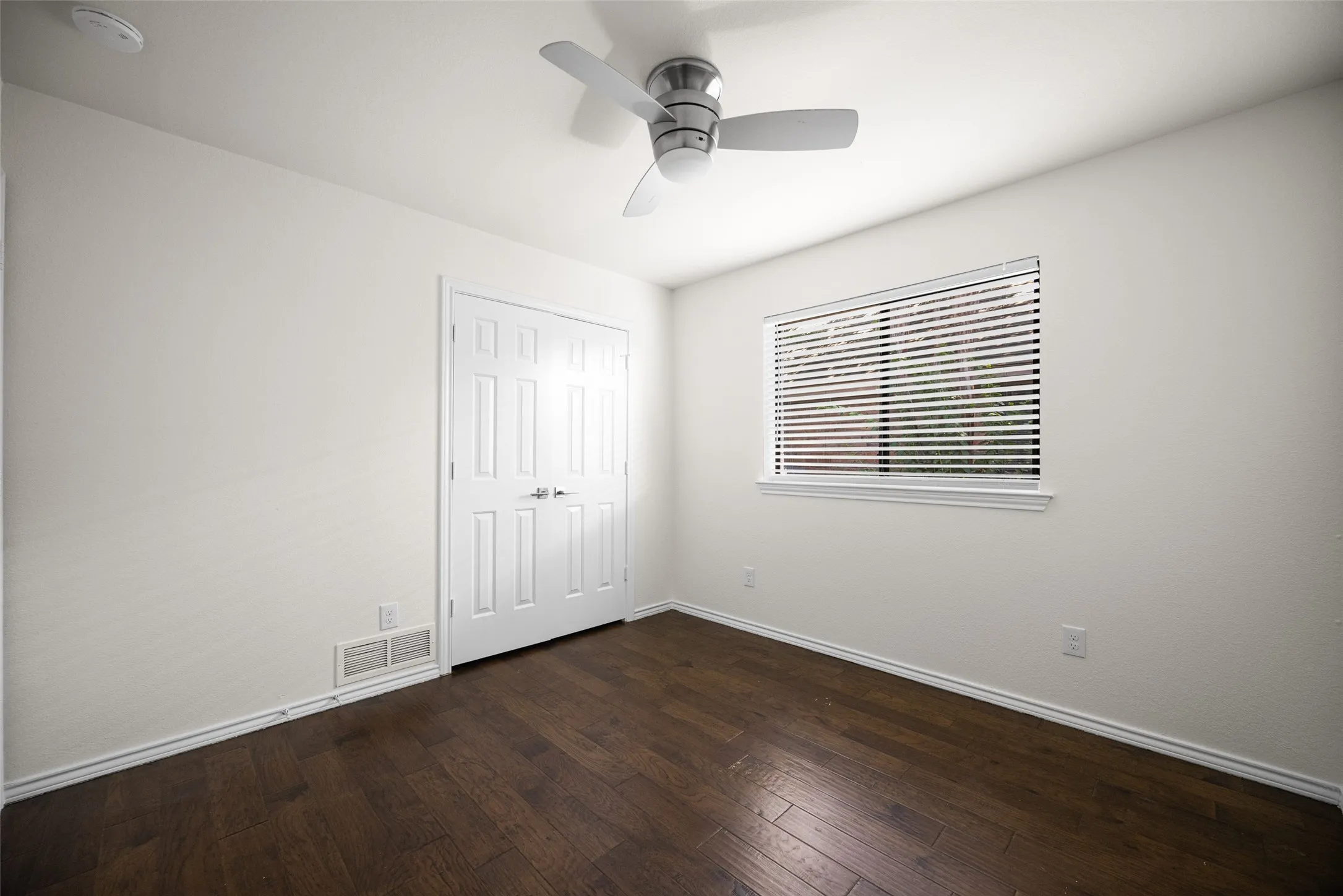 Bedroom with large window and neutral paint