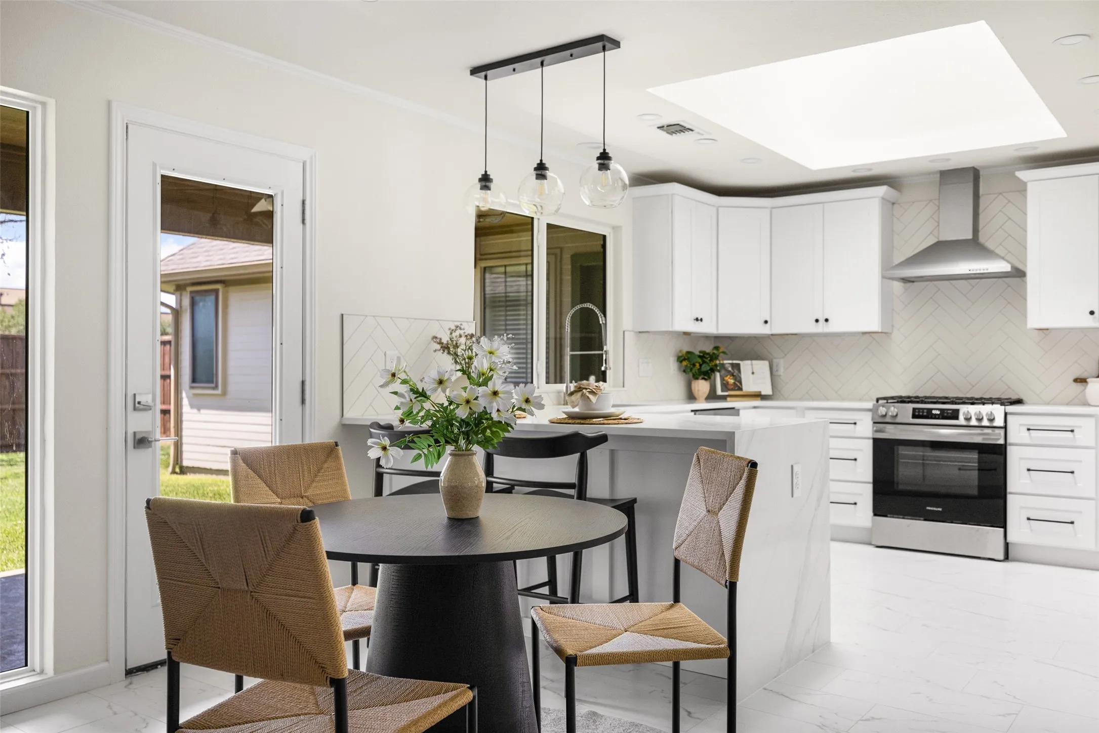 Dining space with designer pendant lighting