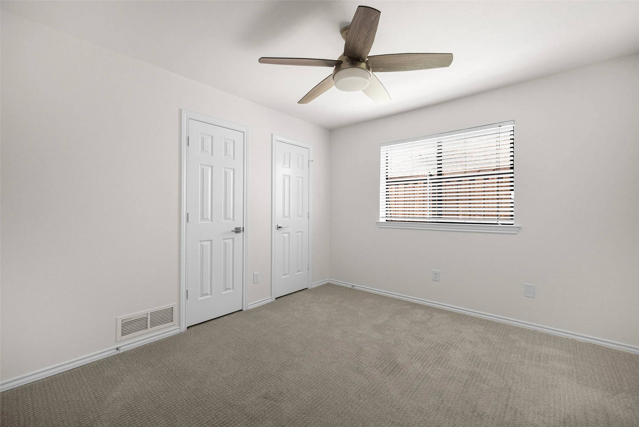Bedroom with carpet flooring and ceiling fan