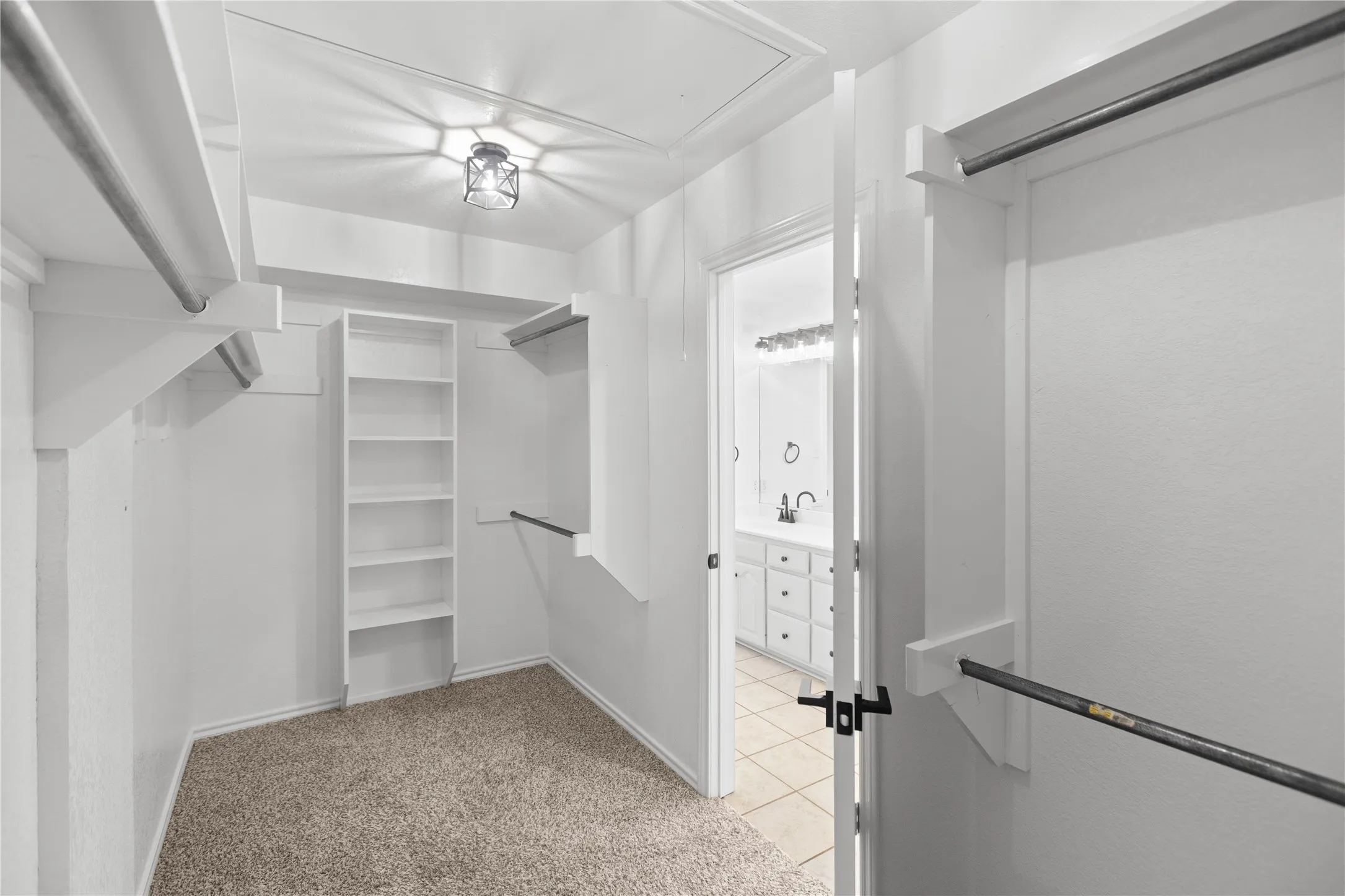 Walk-in closet located in the primary bedroom en-suite.