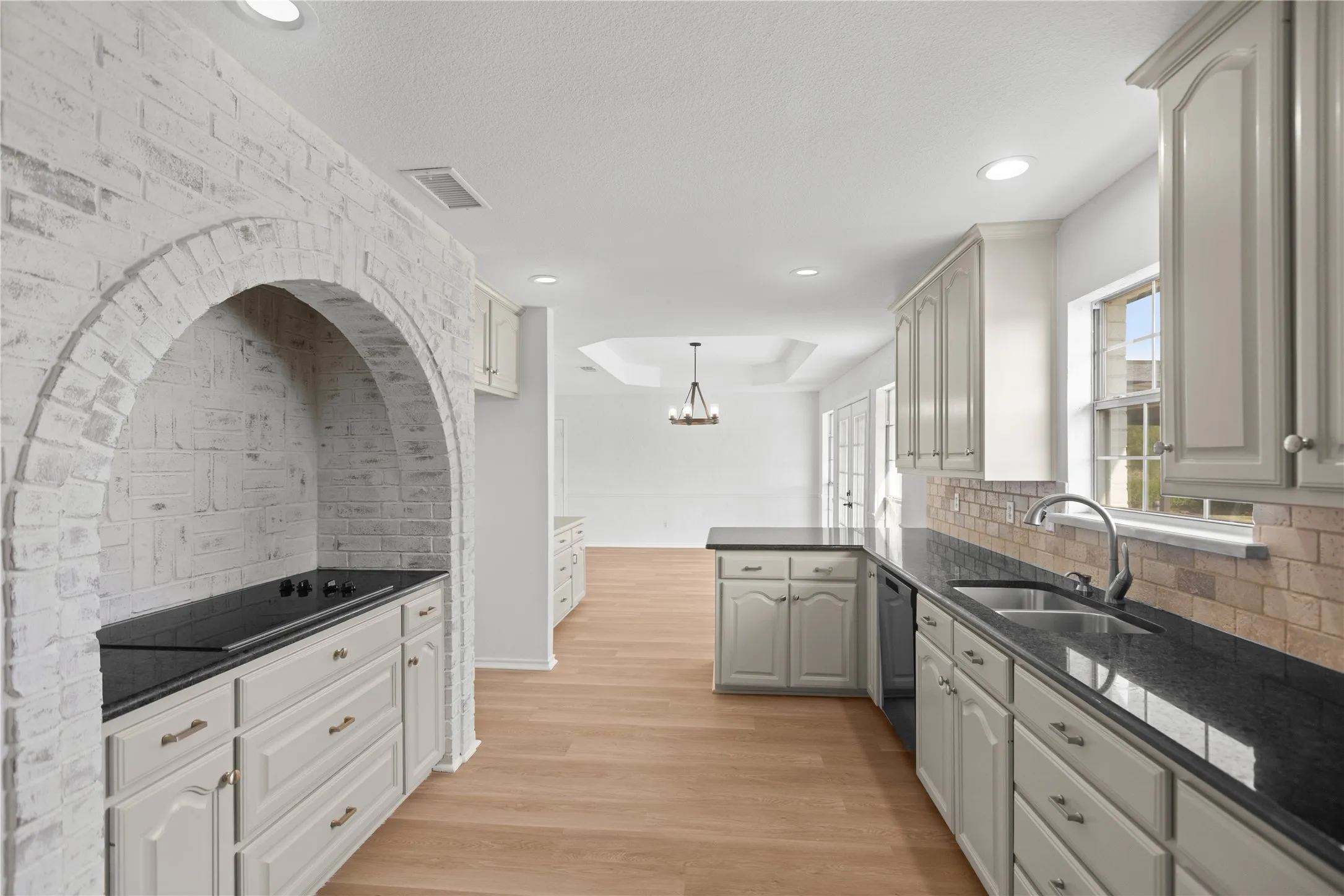 Freshly painted cabinets, abundant countertop space, and plenty of room to keep everything organized make this kitchen as beautiful as it is functional.