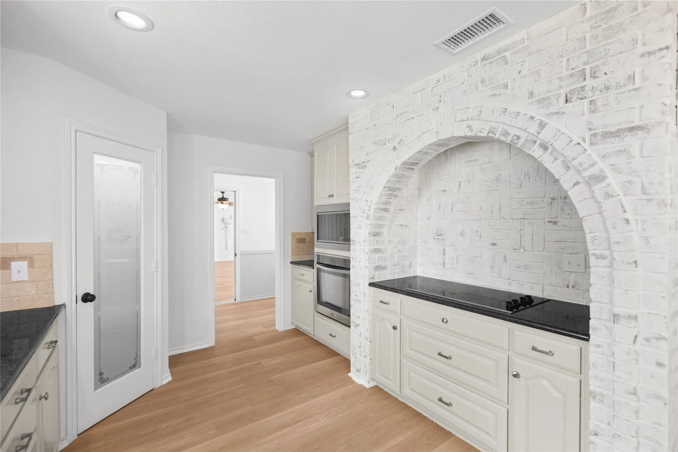 Beautiful brick detailing frames the stove area, adding warmth, texture, and character to the bright kitchen. Plus a good size​​‌​​​​‌​​‌‌​‌‌​​​‌‌​‌​‌​‌​​​‌​​ pantry!