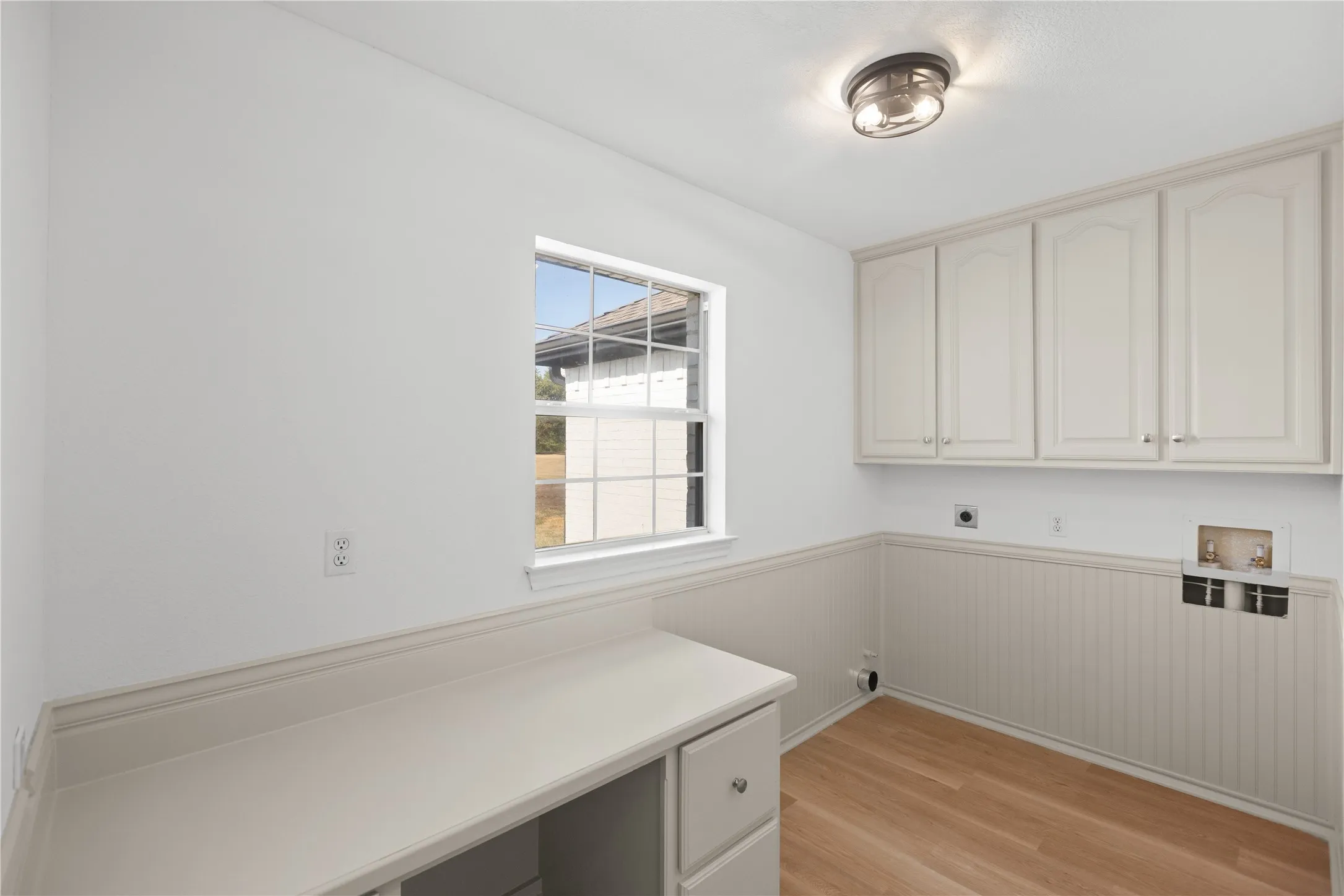 Spacious enough for full-size washer and dryer units, with plenty of storage to keep everything organized.