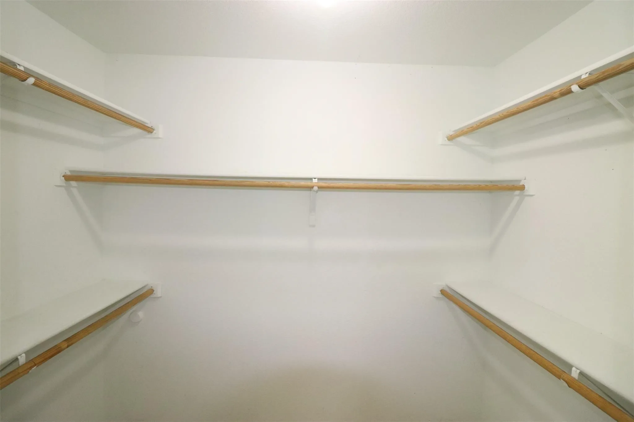 Built-in shelving and closet rods provide functional storage