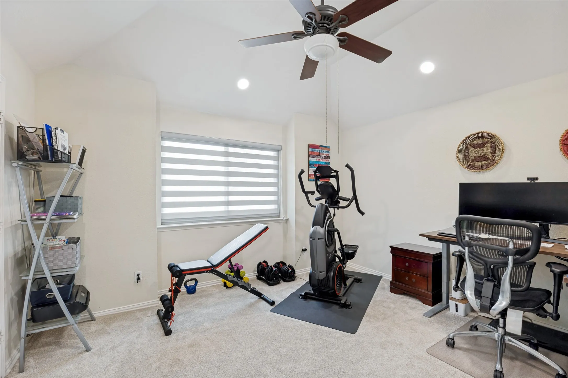Carpeted room with a window, ceiling fan, and recessed lighting