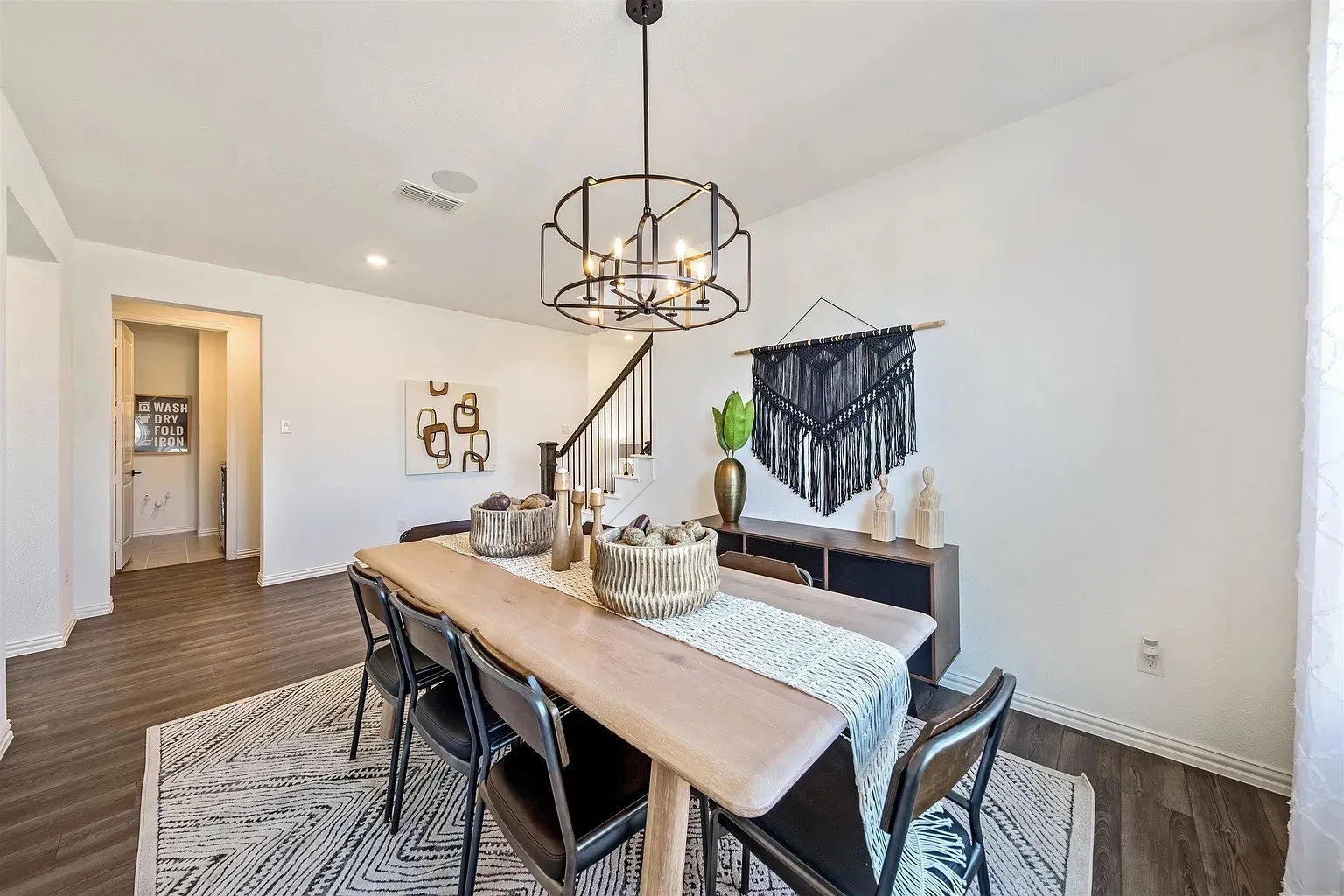Dining area featuring wood-finish flooring, a contemporary chandelier, and recessed lighting