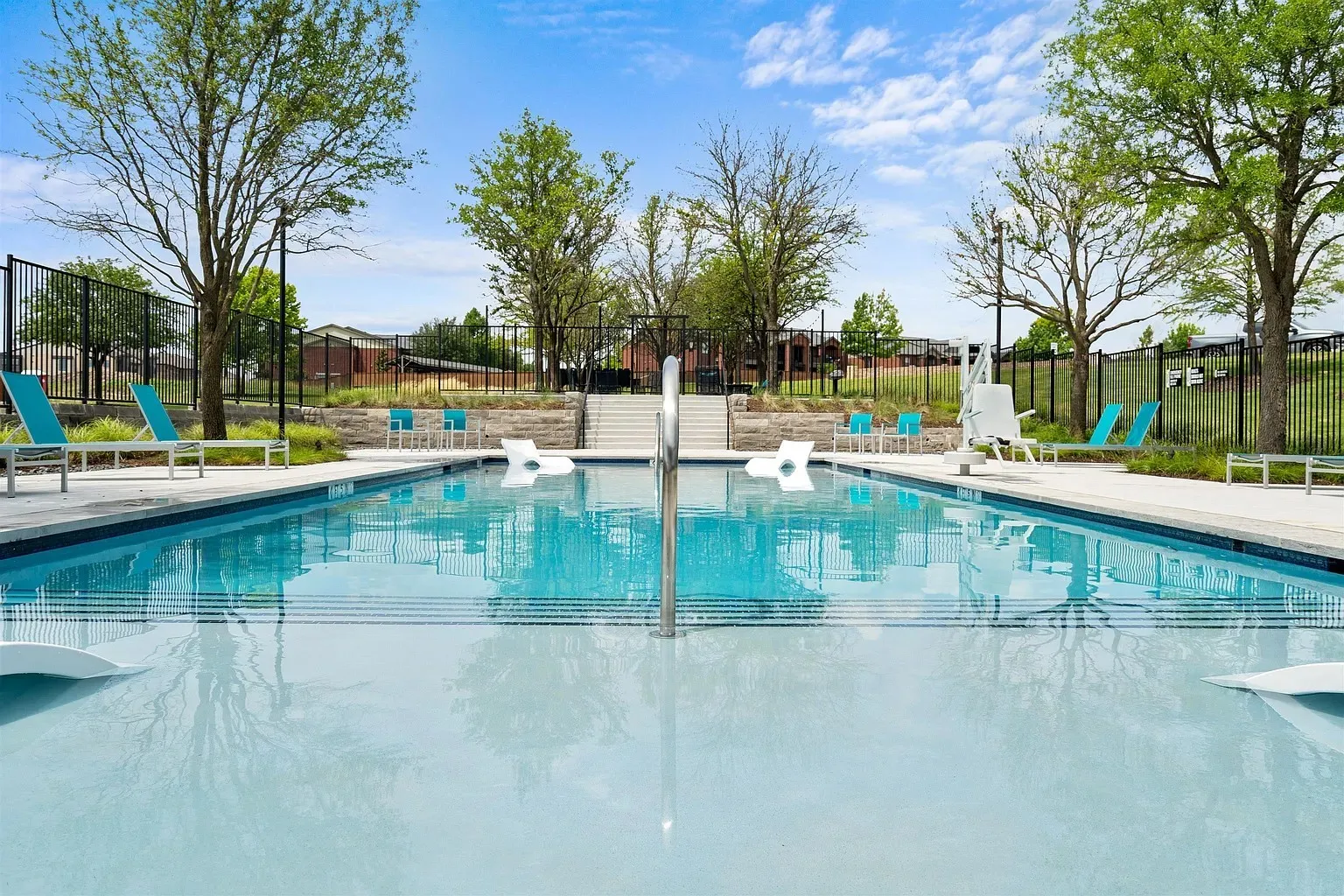 Expansive outdoor pool with integrated sun shelf