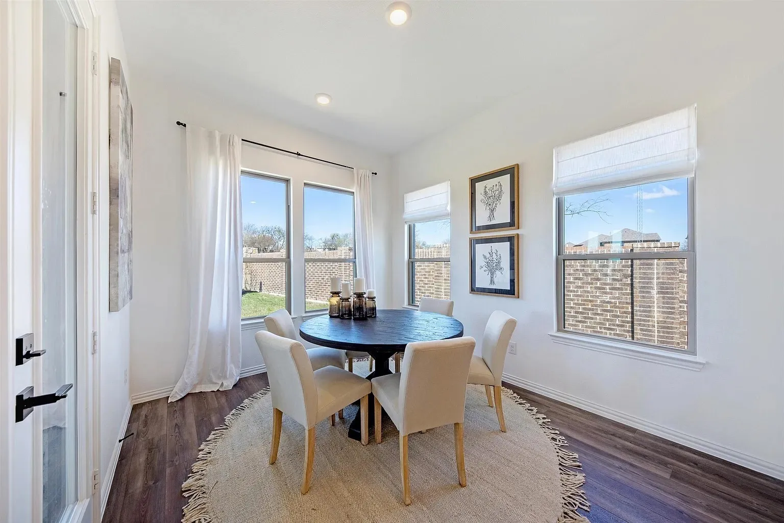 White walls, recessed lighting, and wood-finish flooring