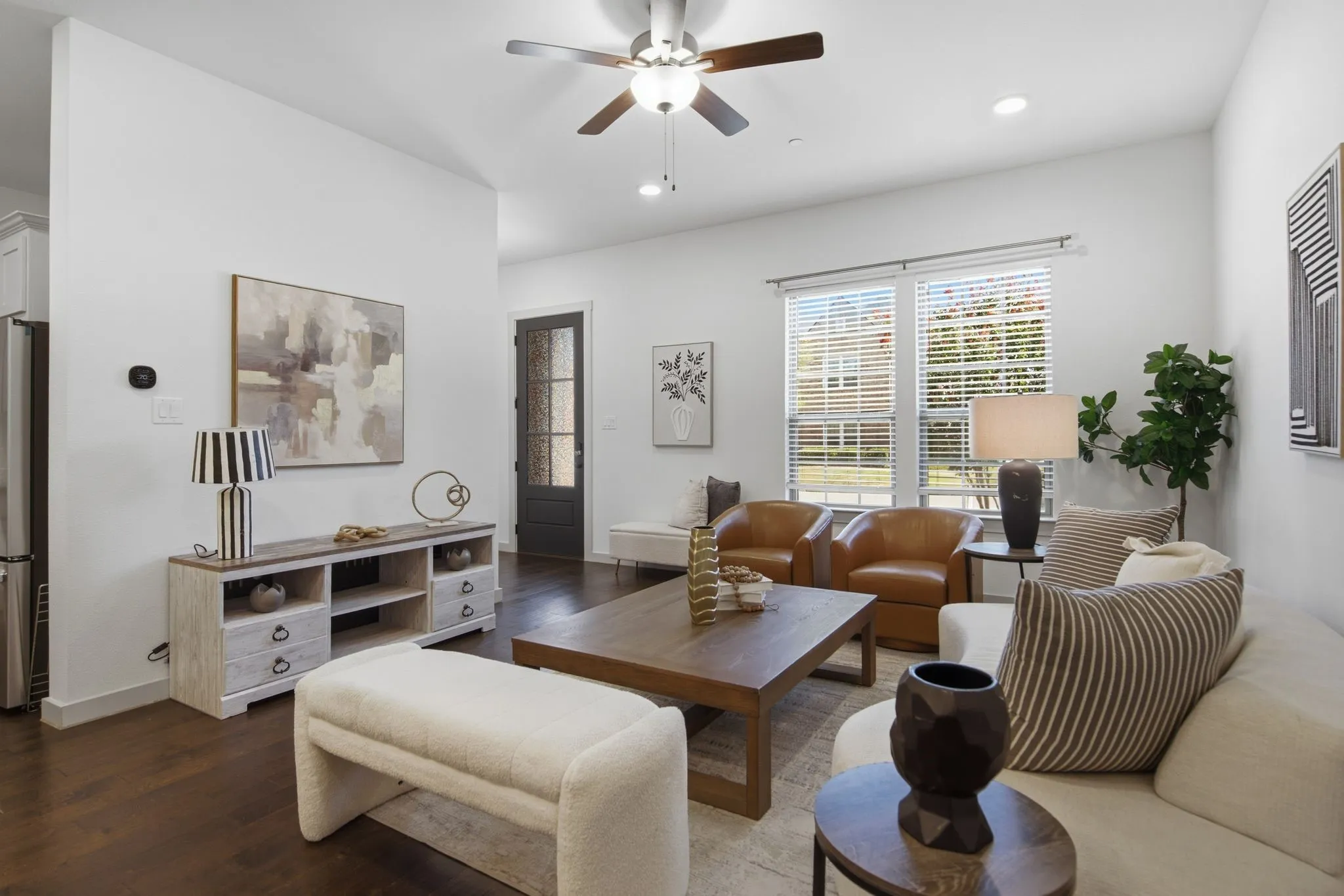 Spacious living area featuring wood-finish flooring, recessed lighting, and a ceiling fan