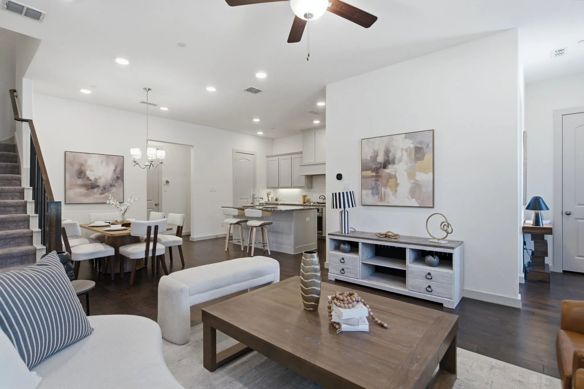 Open-concept living area featuring dark wood-finish flooring, recessed lighting, and a contemporary ceiling fan