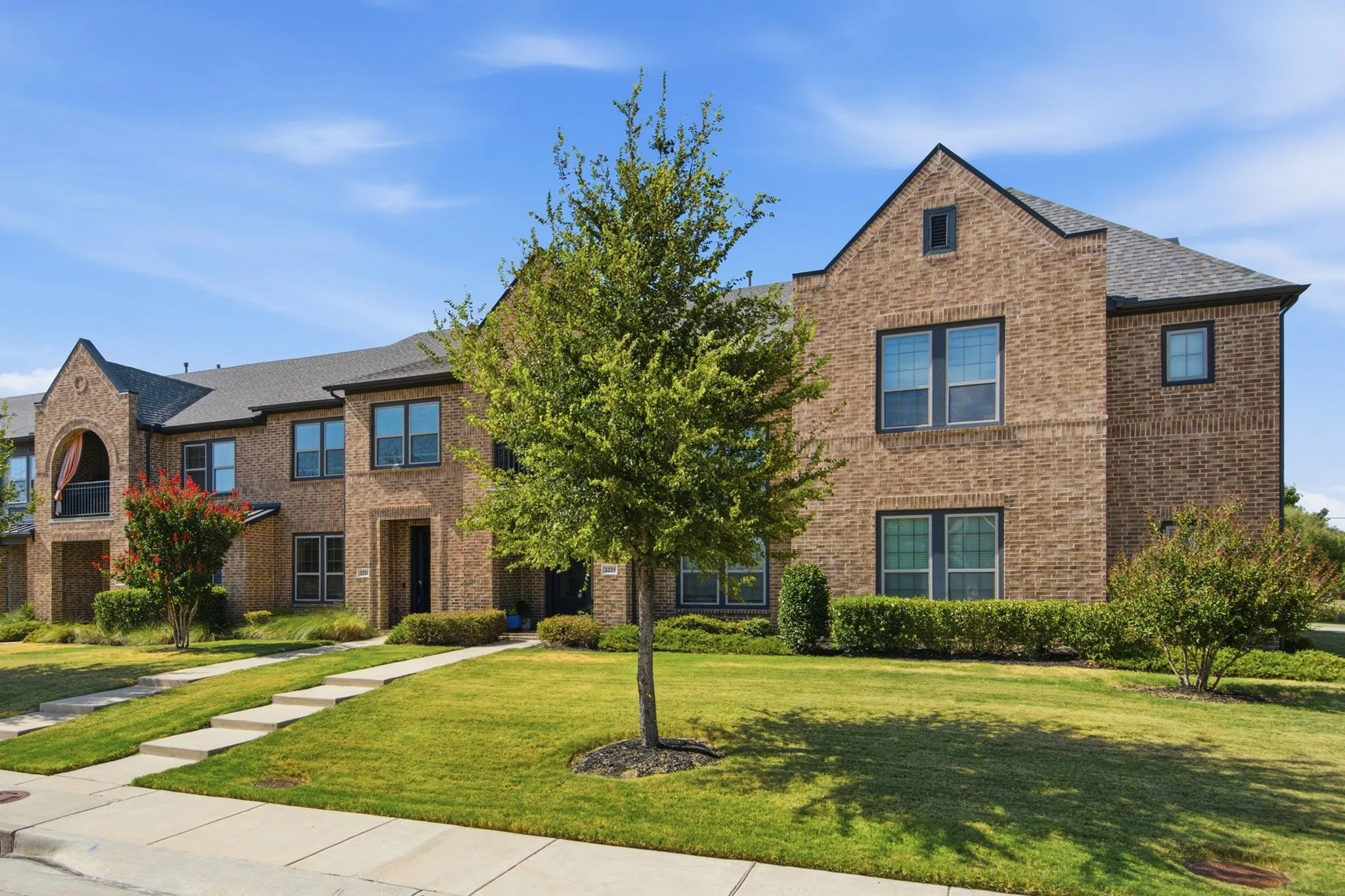 Brick exterior with black-framed windows and a dark shingle roof