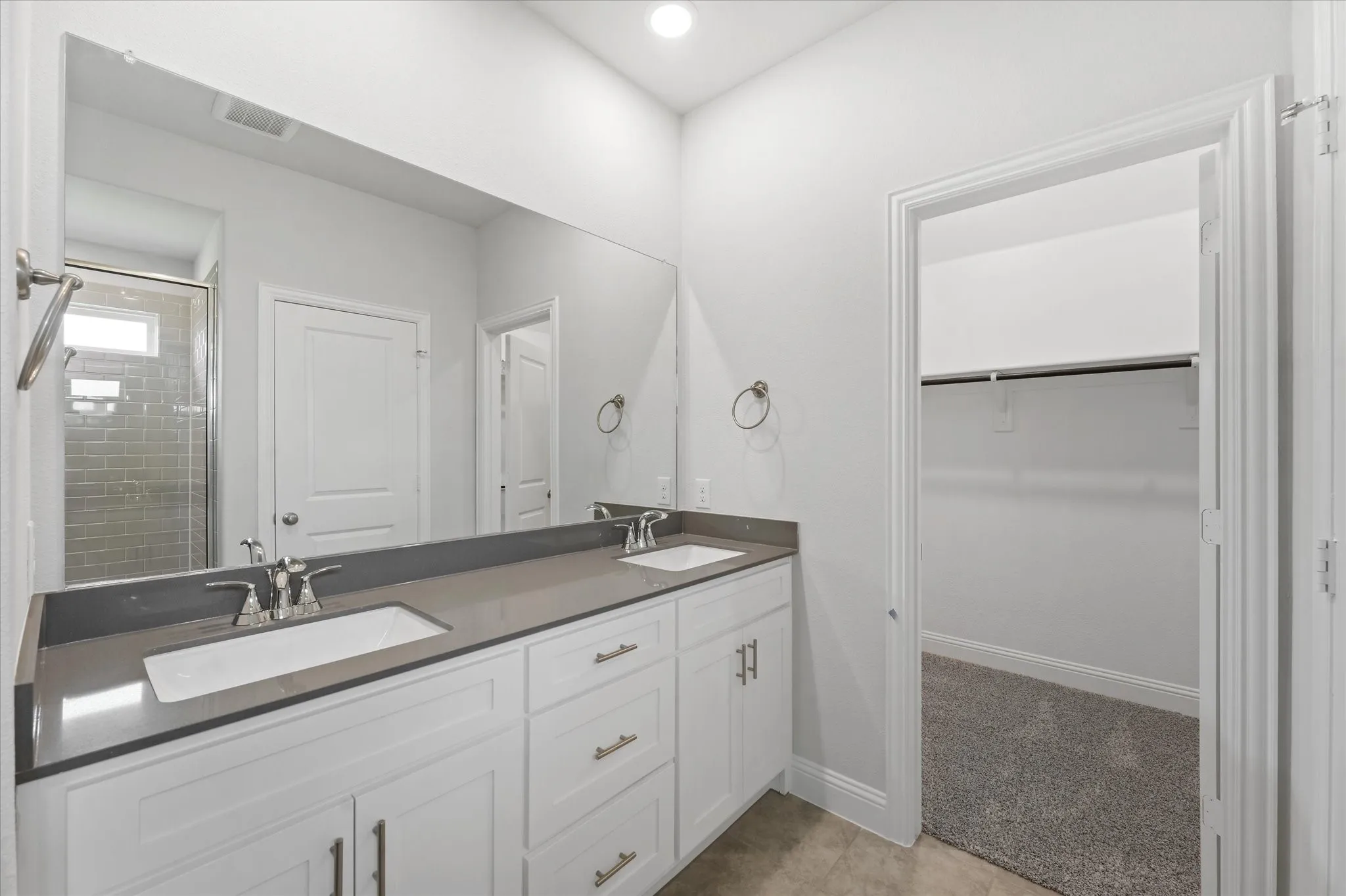 Bathroom featuring dual vanity and tile patterned floors