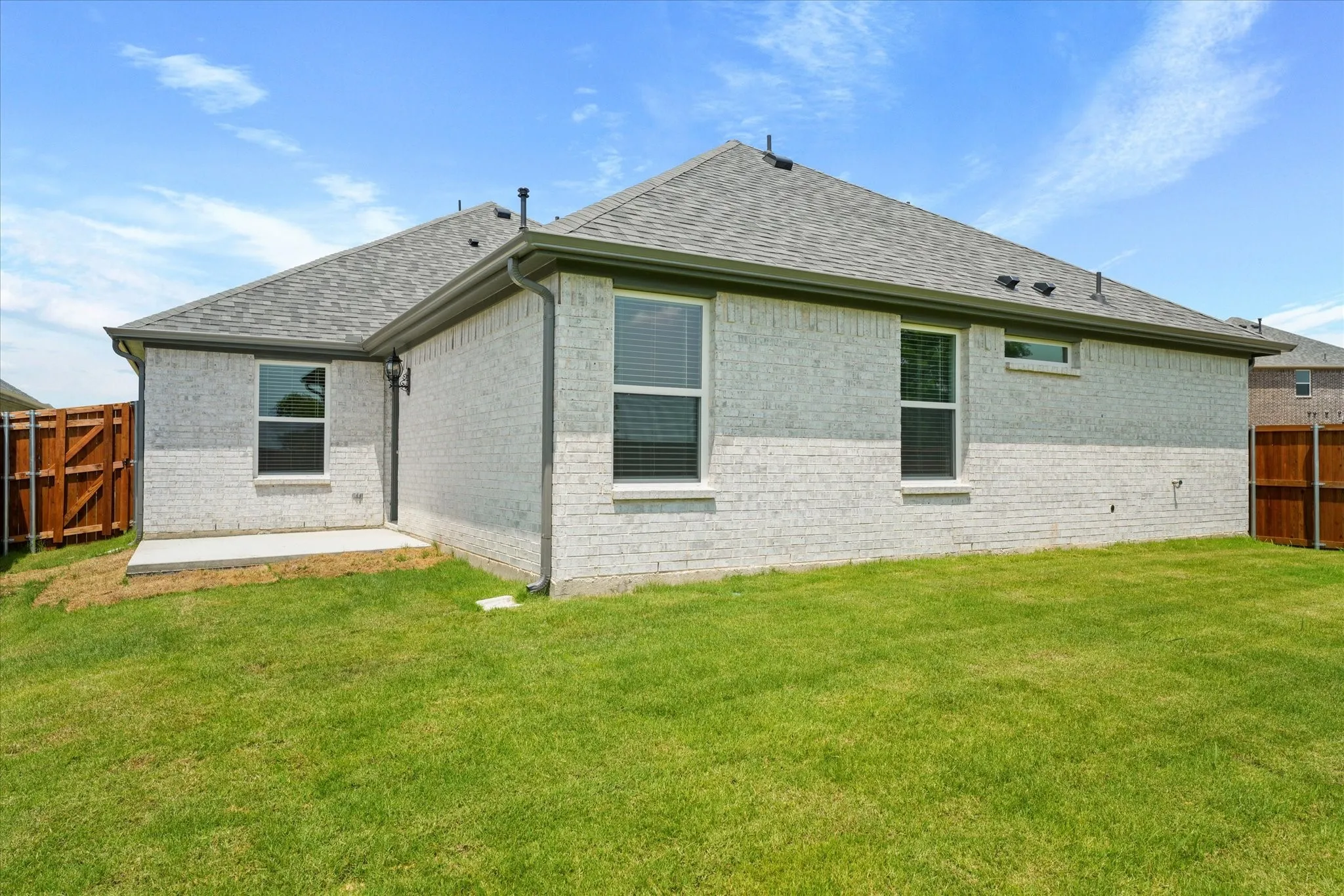Rear view of property with a lawn
